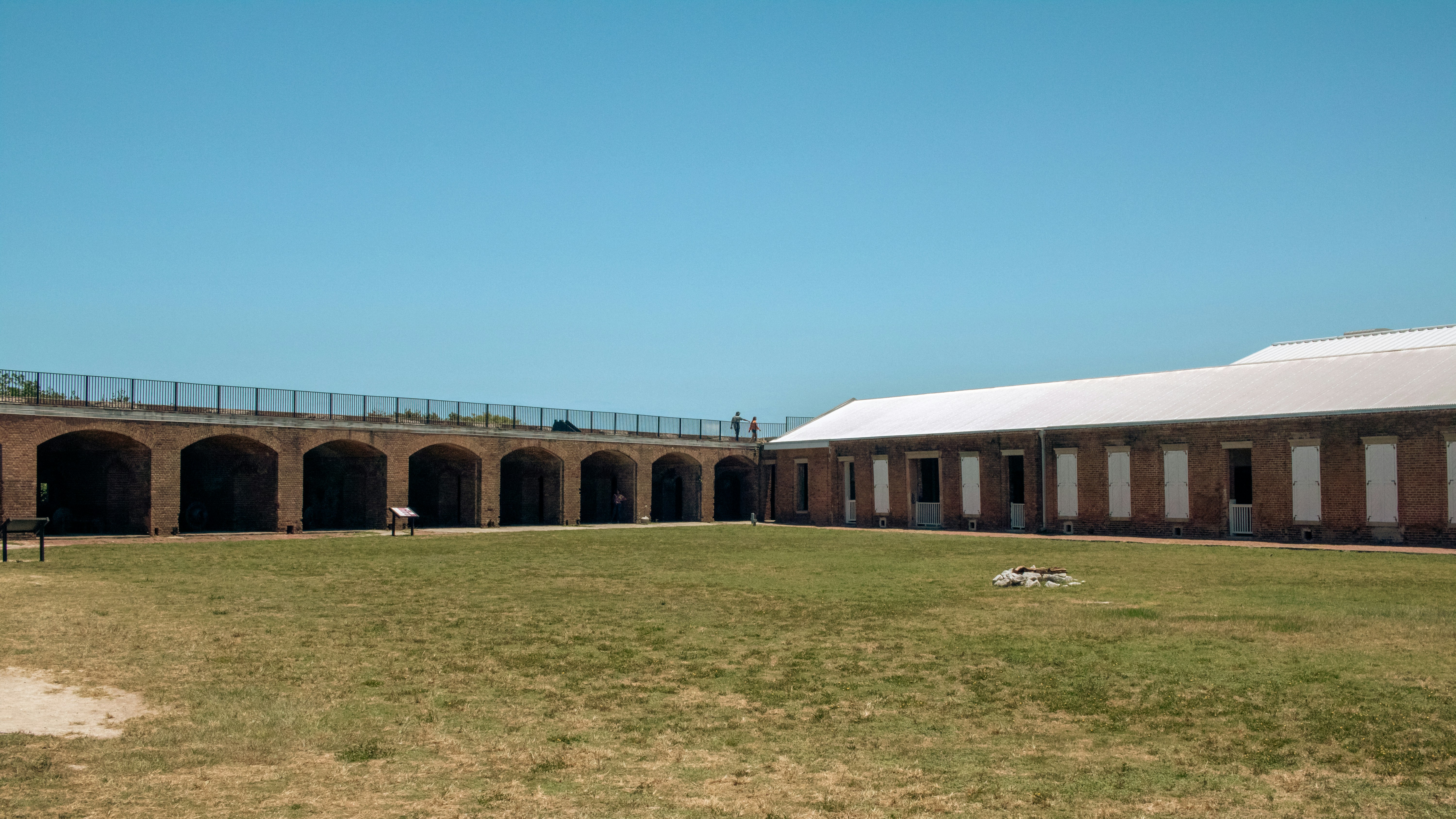 A large building with a grassy field in front of it