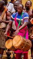 A group of men standing next to each other holding drums