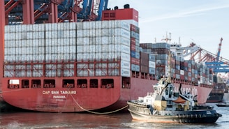 A large red and white container ship in the water