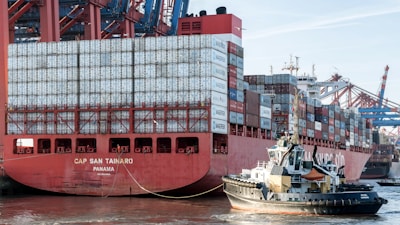 A large red and white container ship in the water