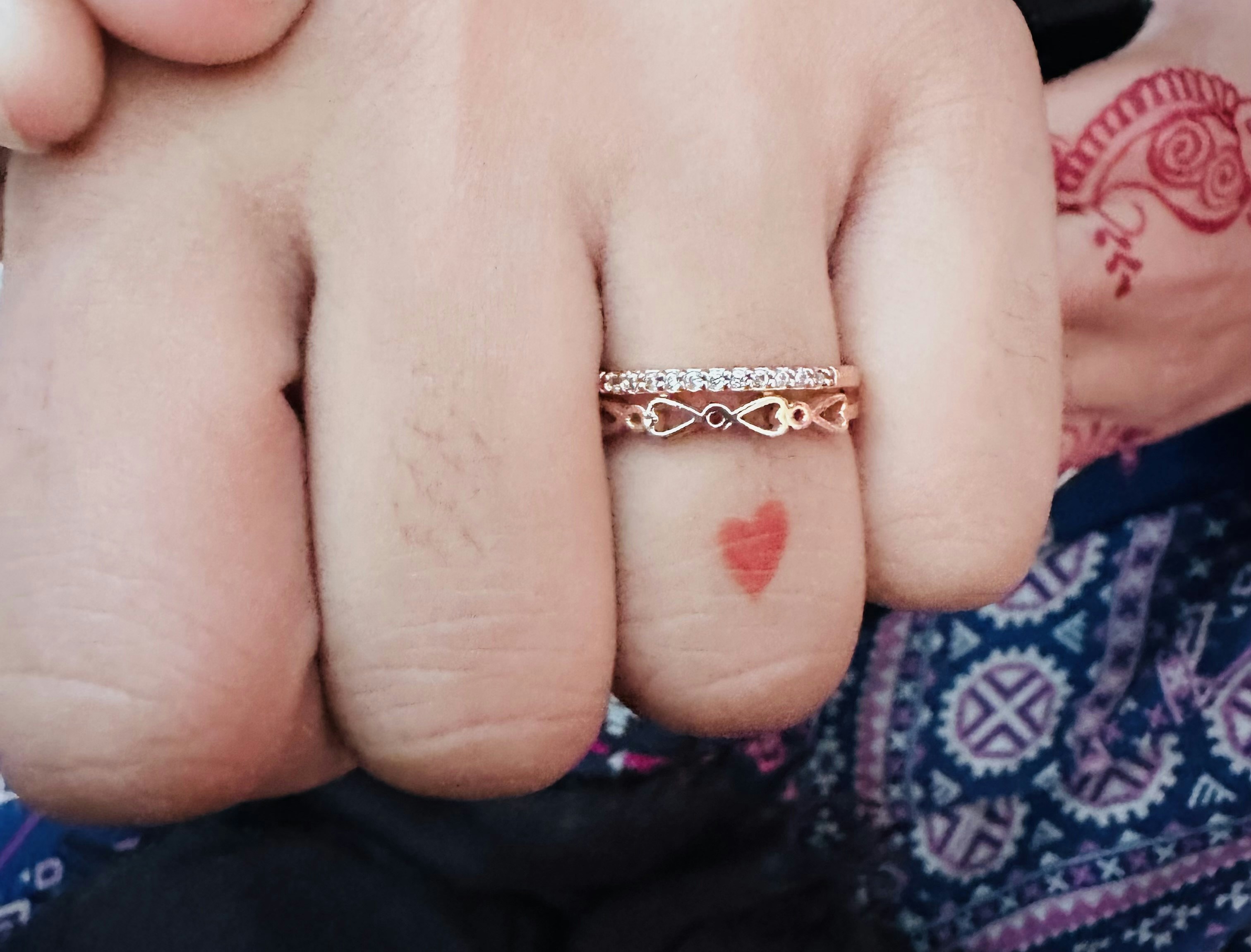 A close up of a person holding a ring