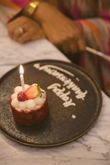 A small cake with a candle on top of it