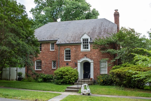 A car parked in front of a brick house
