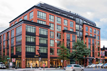 A large red brick building sitting on the corner of a street