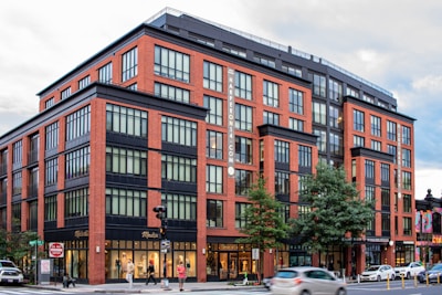 A large red brick building sitting on the corner of a street