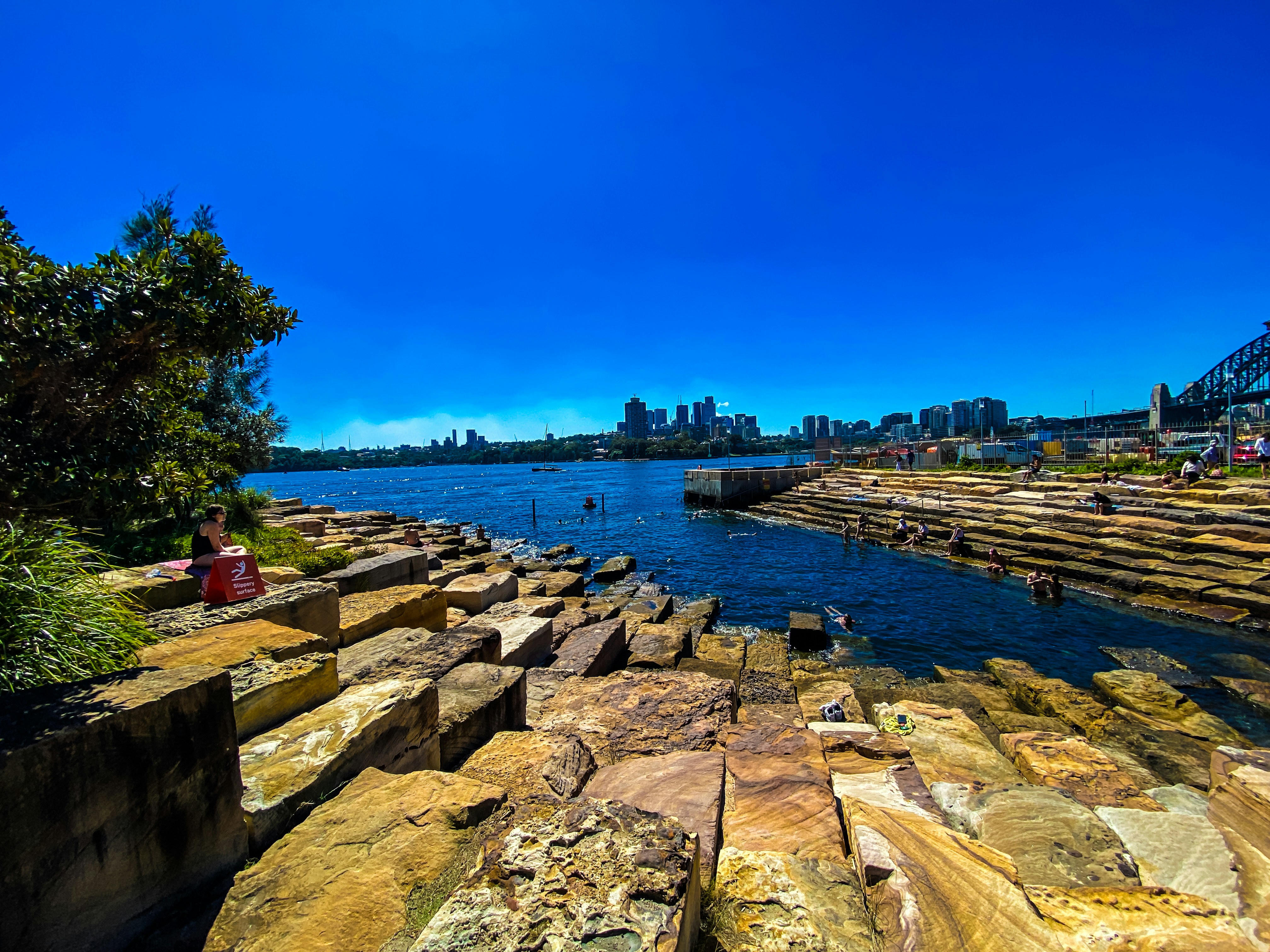 A large body of water with a bridge in the background
