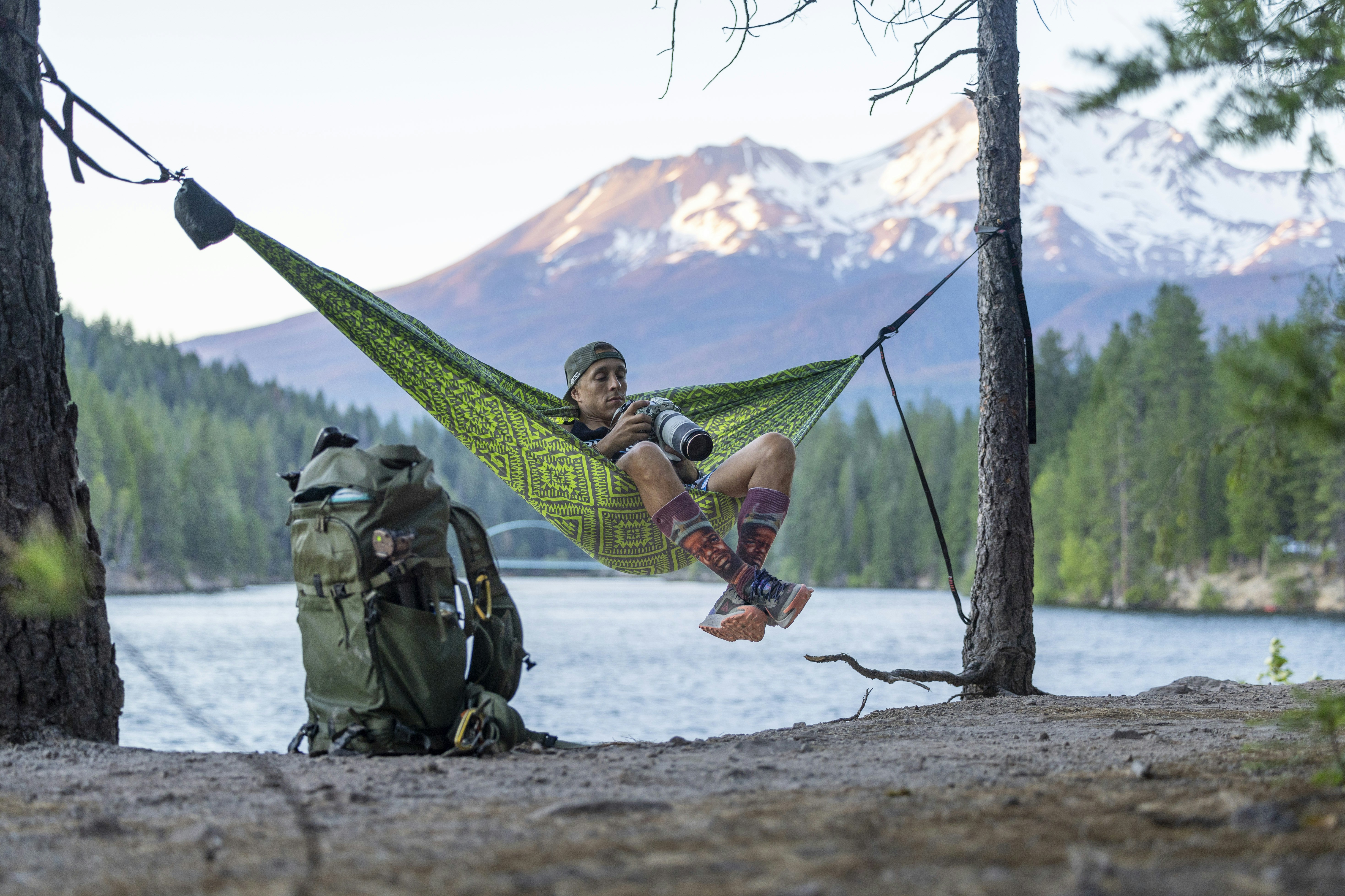 A man in a hammock hanging from a tree