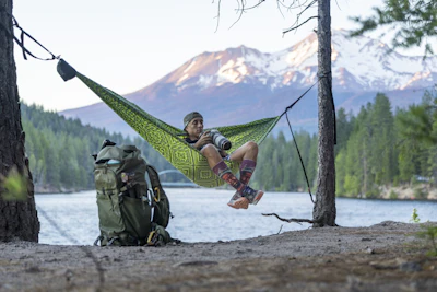 A man in a hammock hanging from a tree