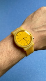 A person wearing a yellow watch on their wrist