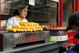 A woman standing in front of a food stand