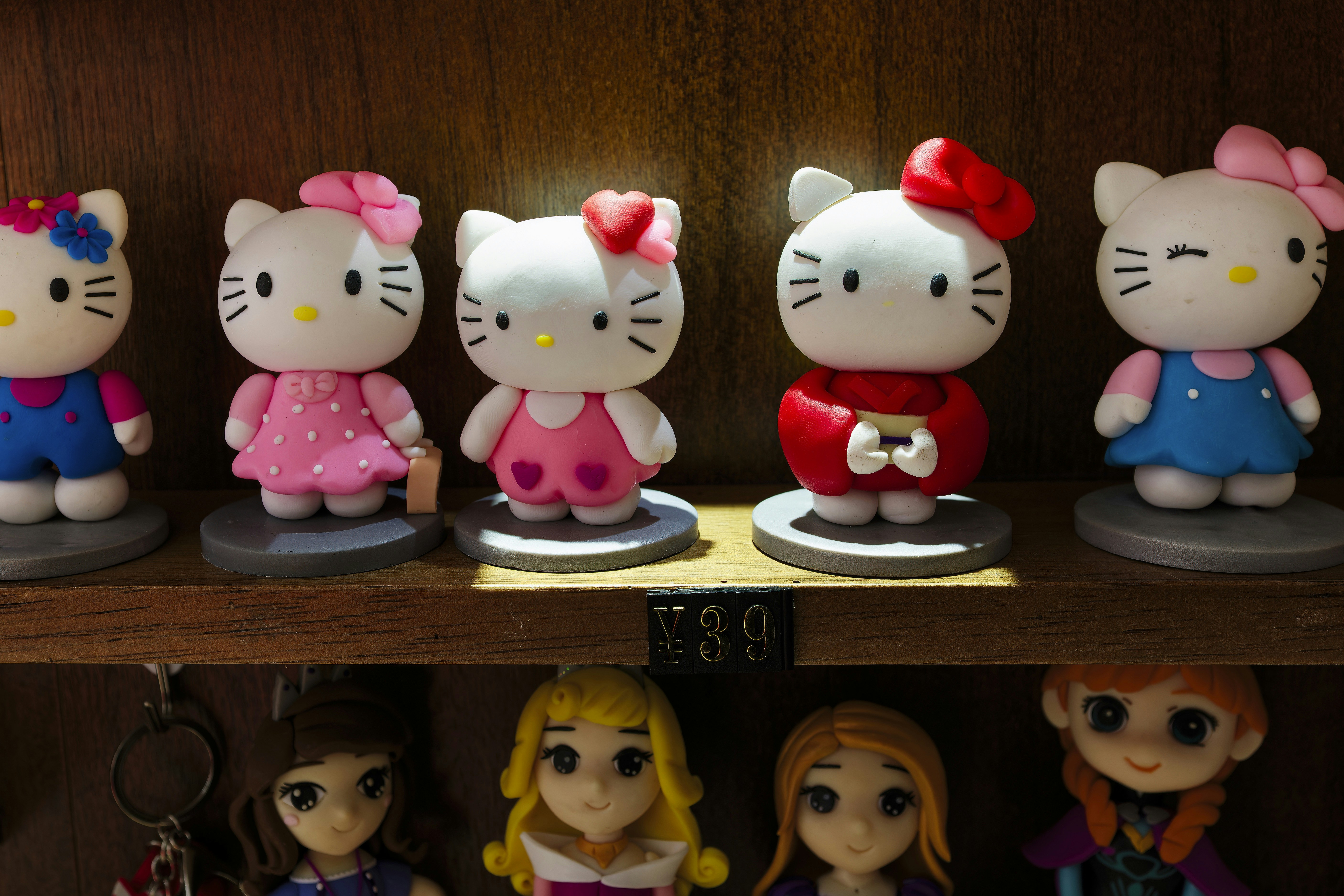A shelf with hello kitty figurines on it