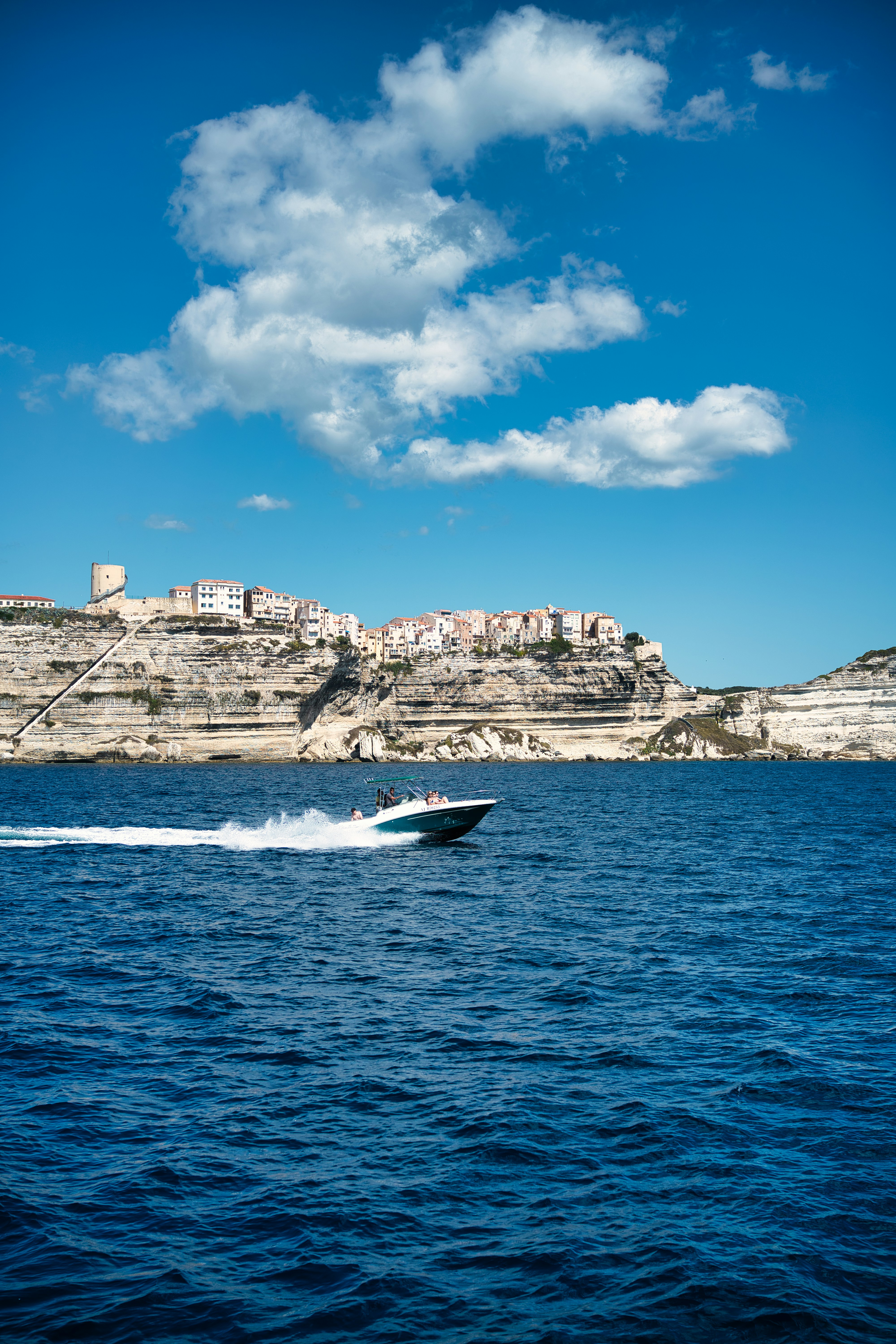 A speed boat in the middle of a body of water