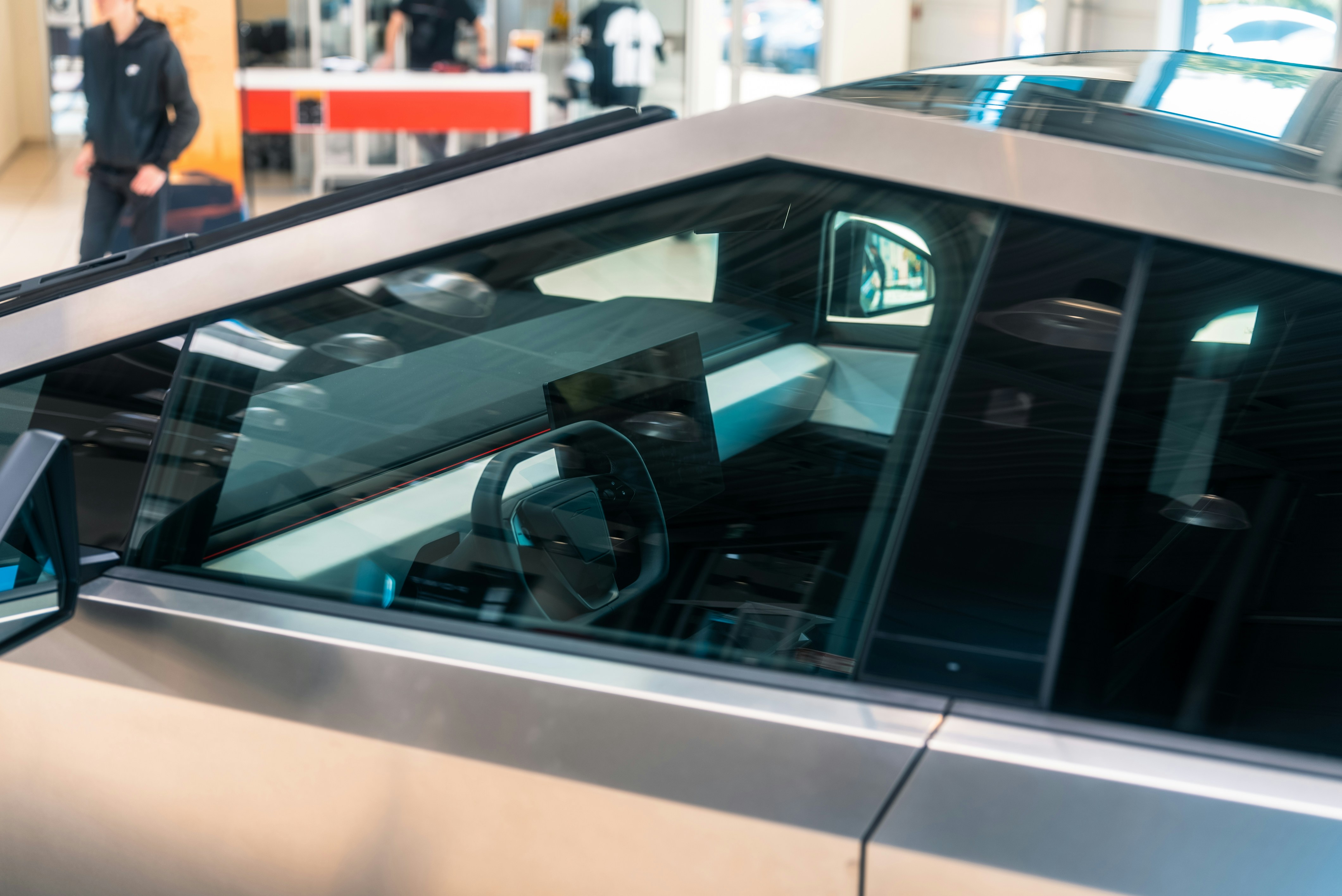 A silver car parked in a parking garage