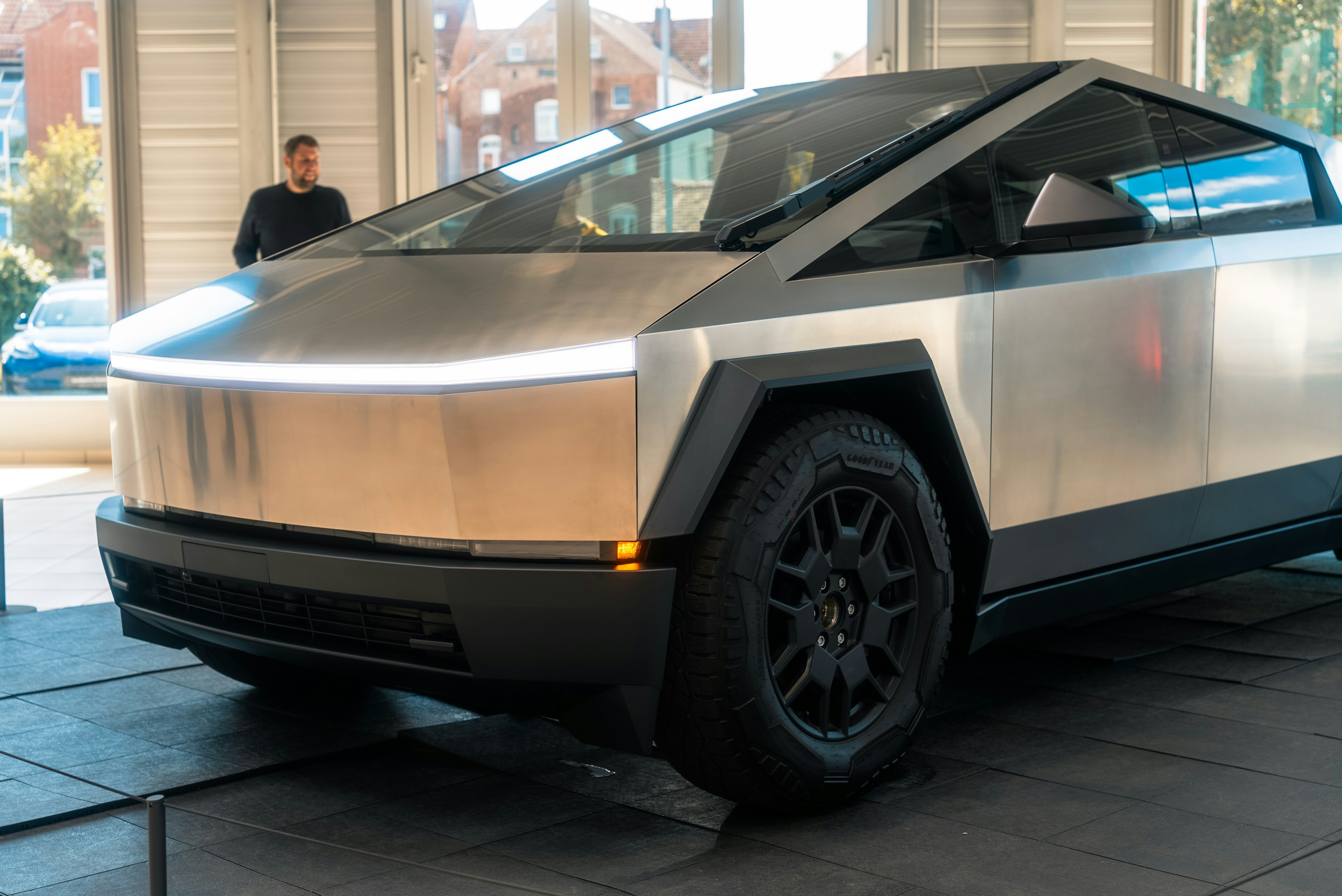 A silver car parked in front of a building