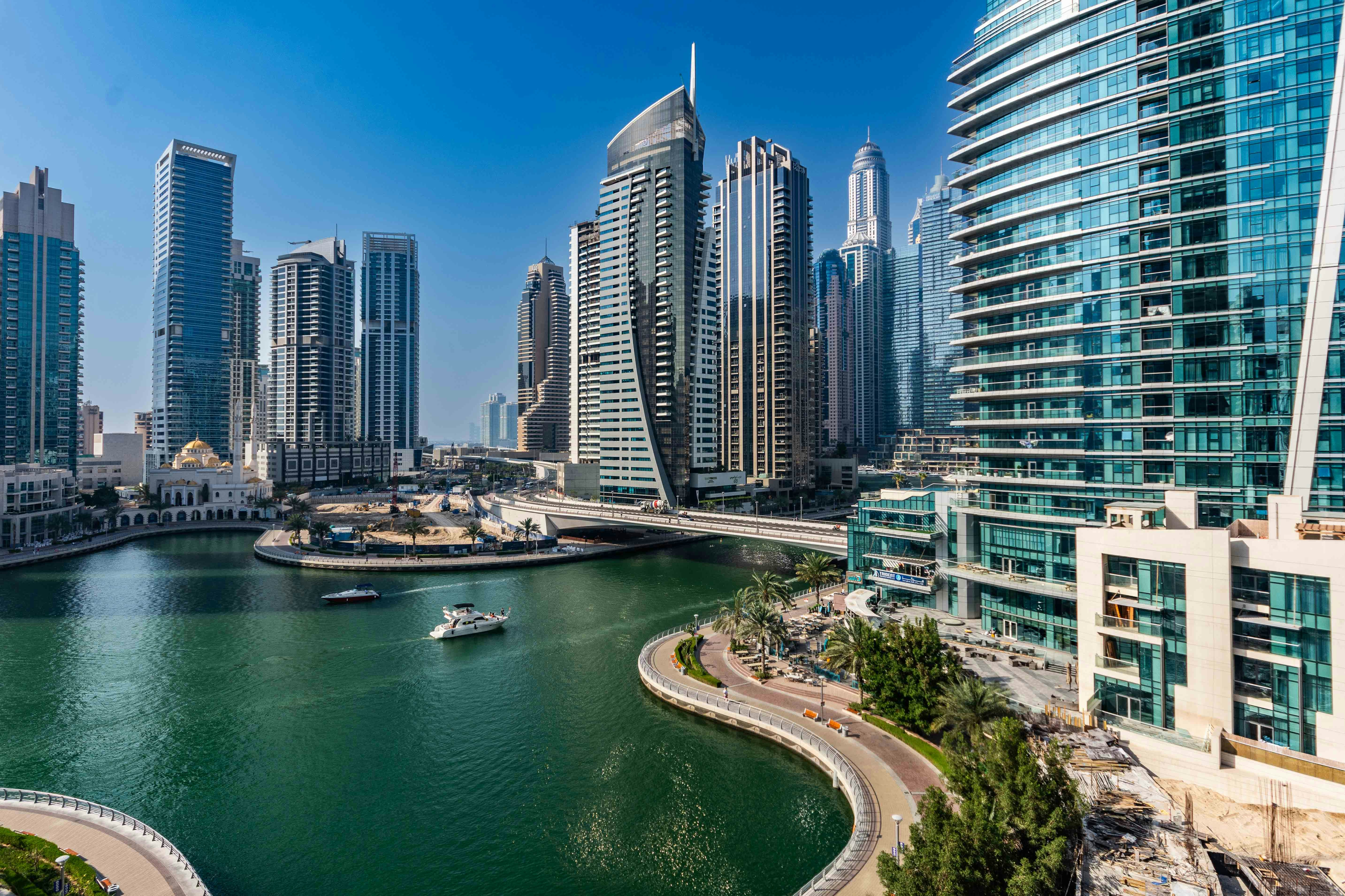 A river running through a city next to tall buildings