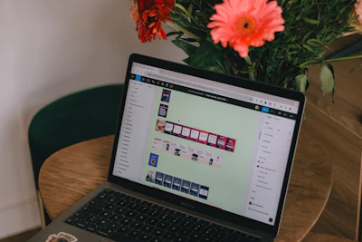 A laptop computer sitting on top of a wooden table