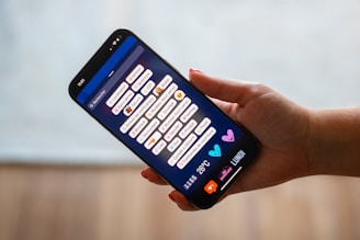 A person holding a cell phone in their hand