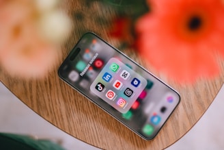 A cell phone sitting on top of a wooden table