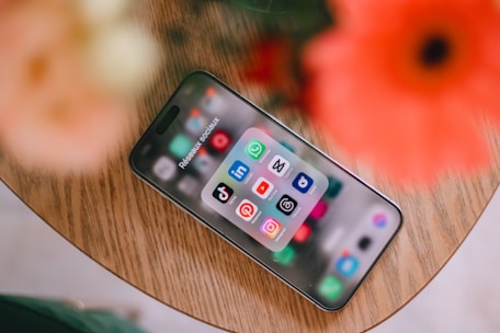 A cell phone sitting on top of a wooden table