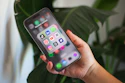 A person holding a cell phone in their hand