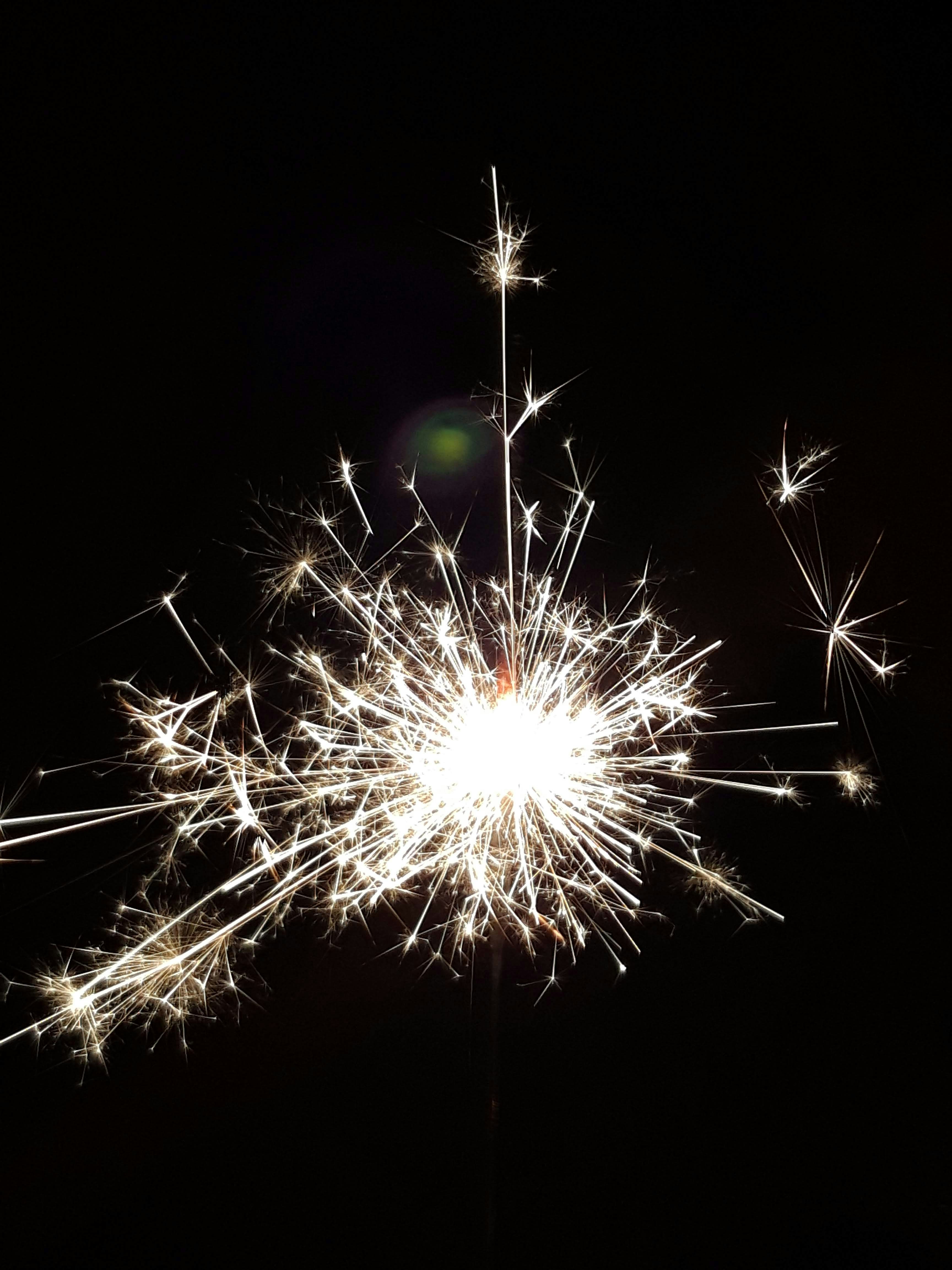A close up of a sparkler on a black background