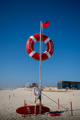A life preserver on the beach with a life preserver in the background