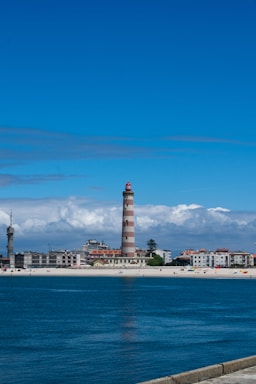 A large body of water with a lighthouse in the background