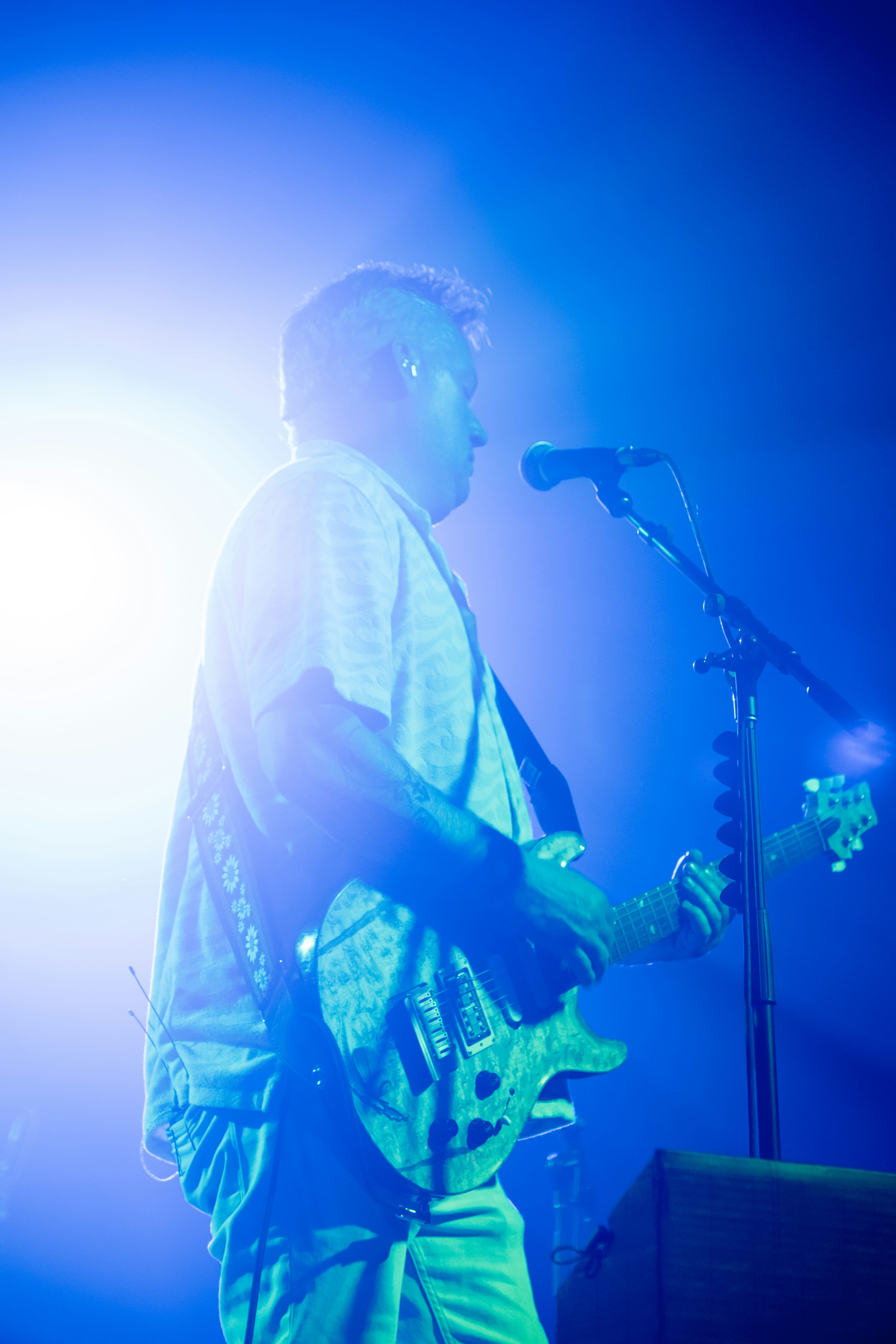 A man standing in front of a microphone on a stage
