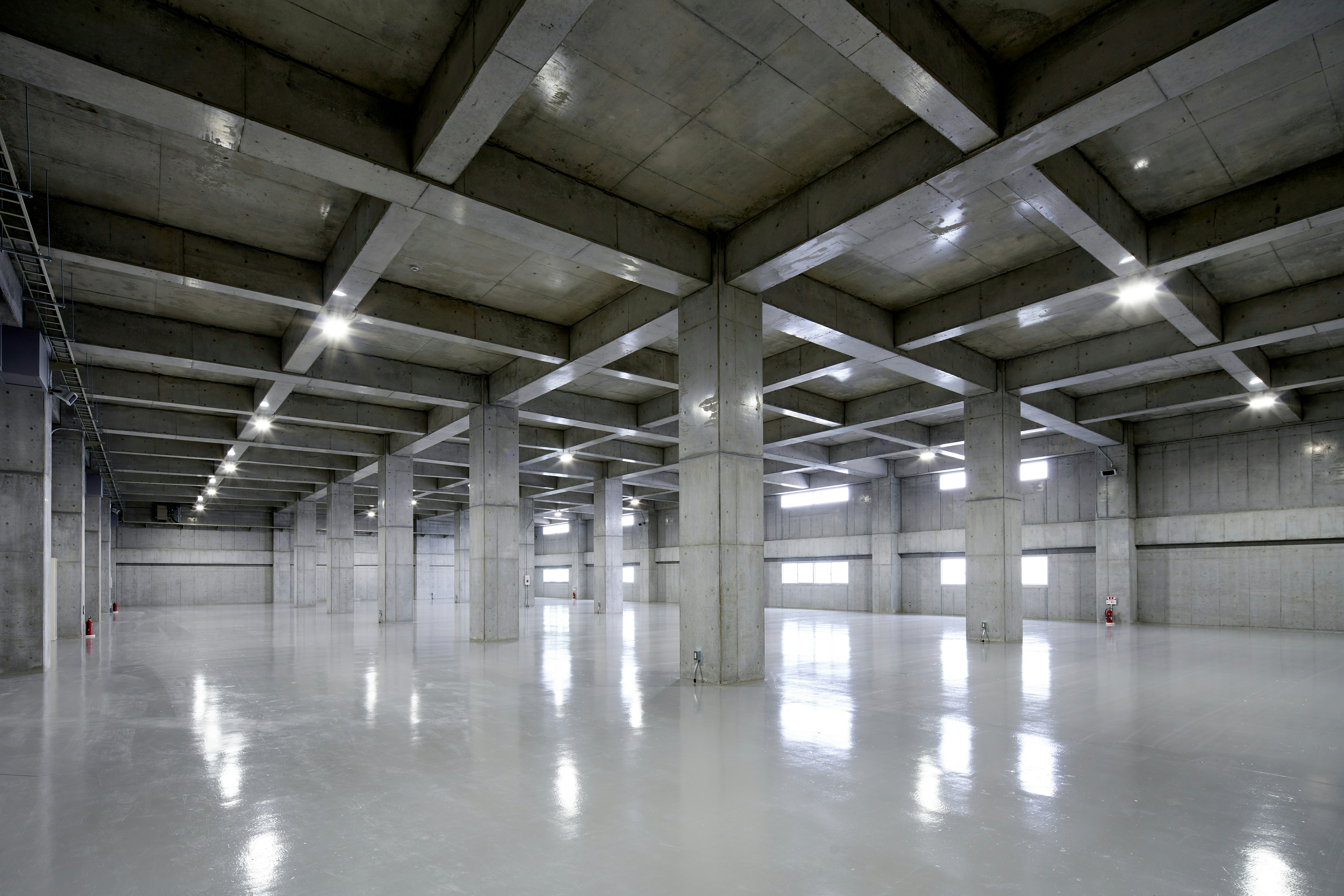 An empty parking garage with lights on the ceiling