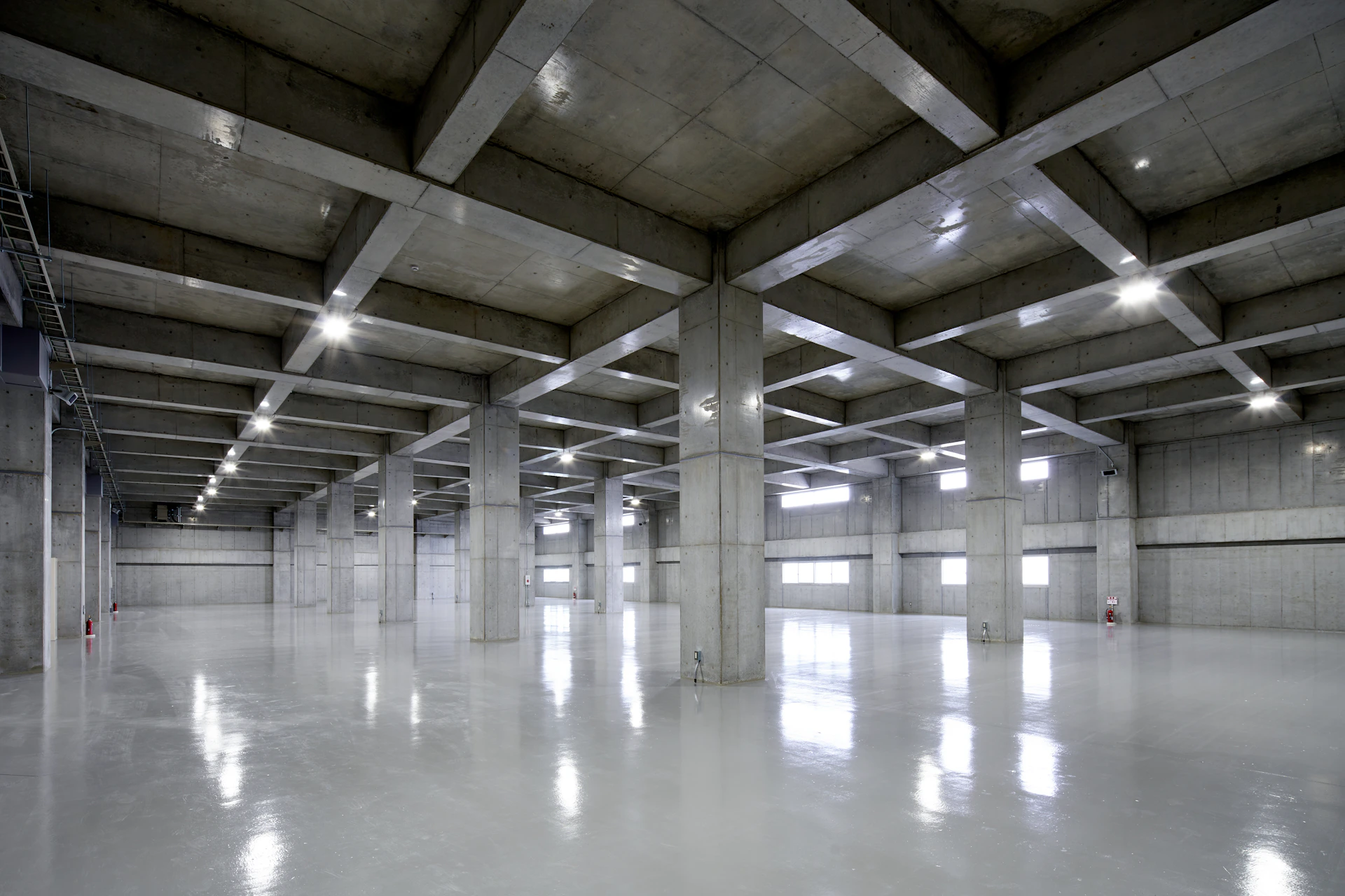 An empty parking garage with lights on the ceiling
