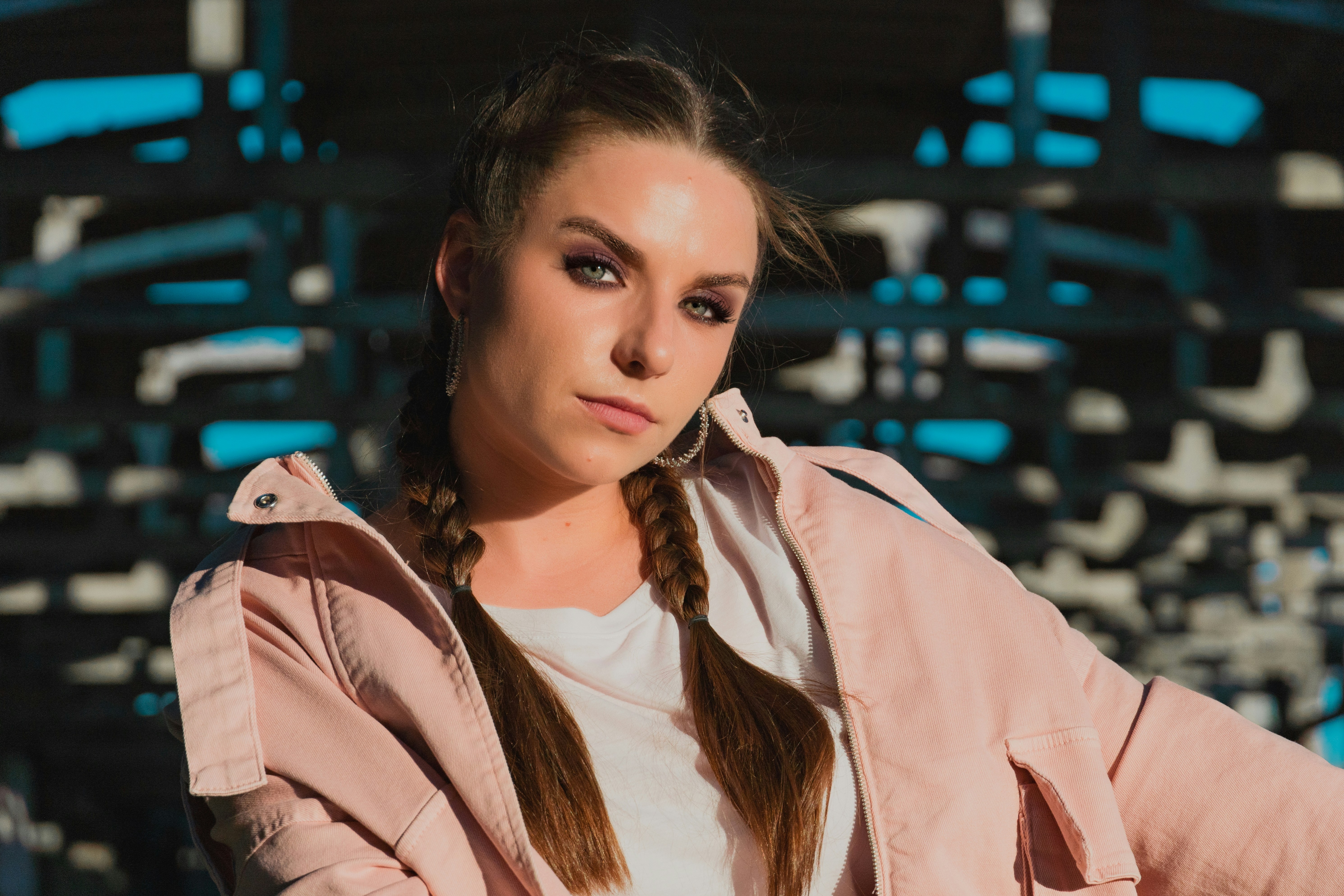 A woman with long hair wearing a pink jacket