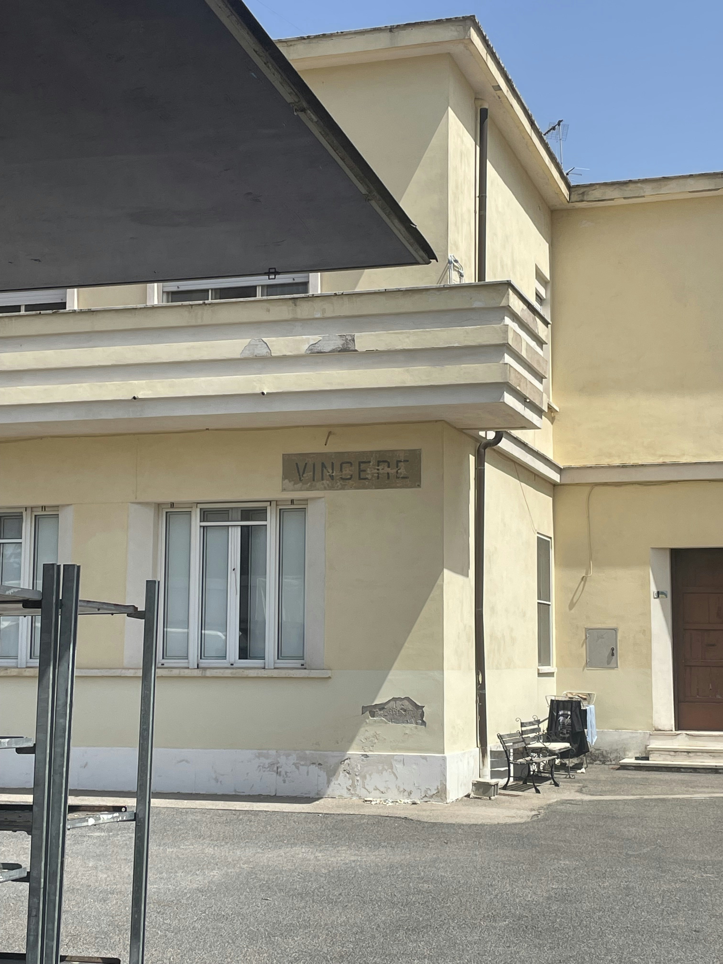 A building with a black umbrella in front of it