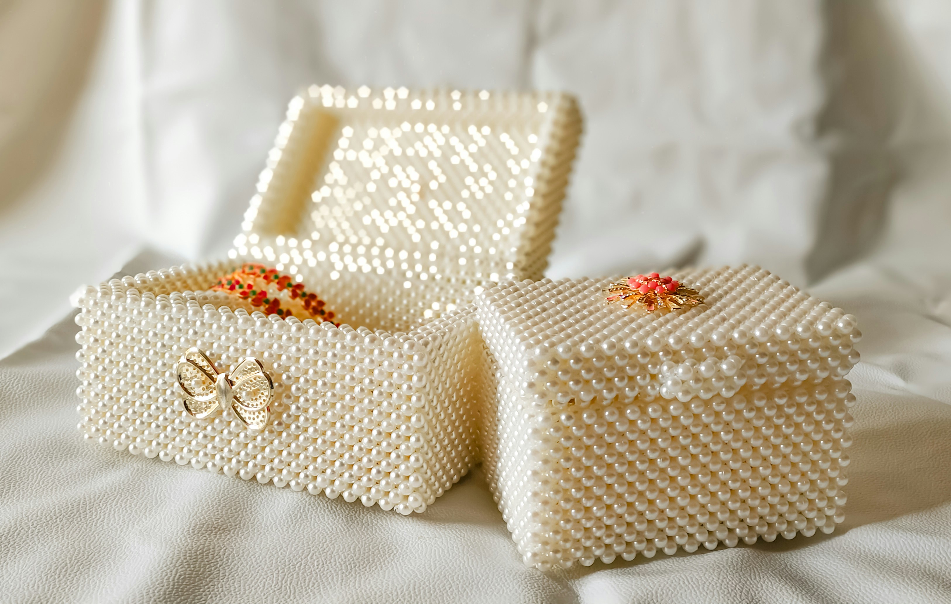 A couple of white boxes sitting on top of a bed