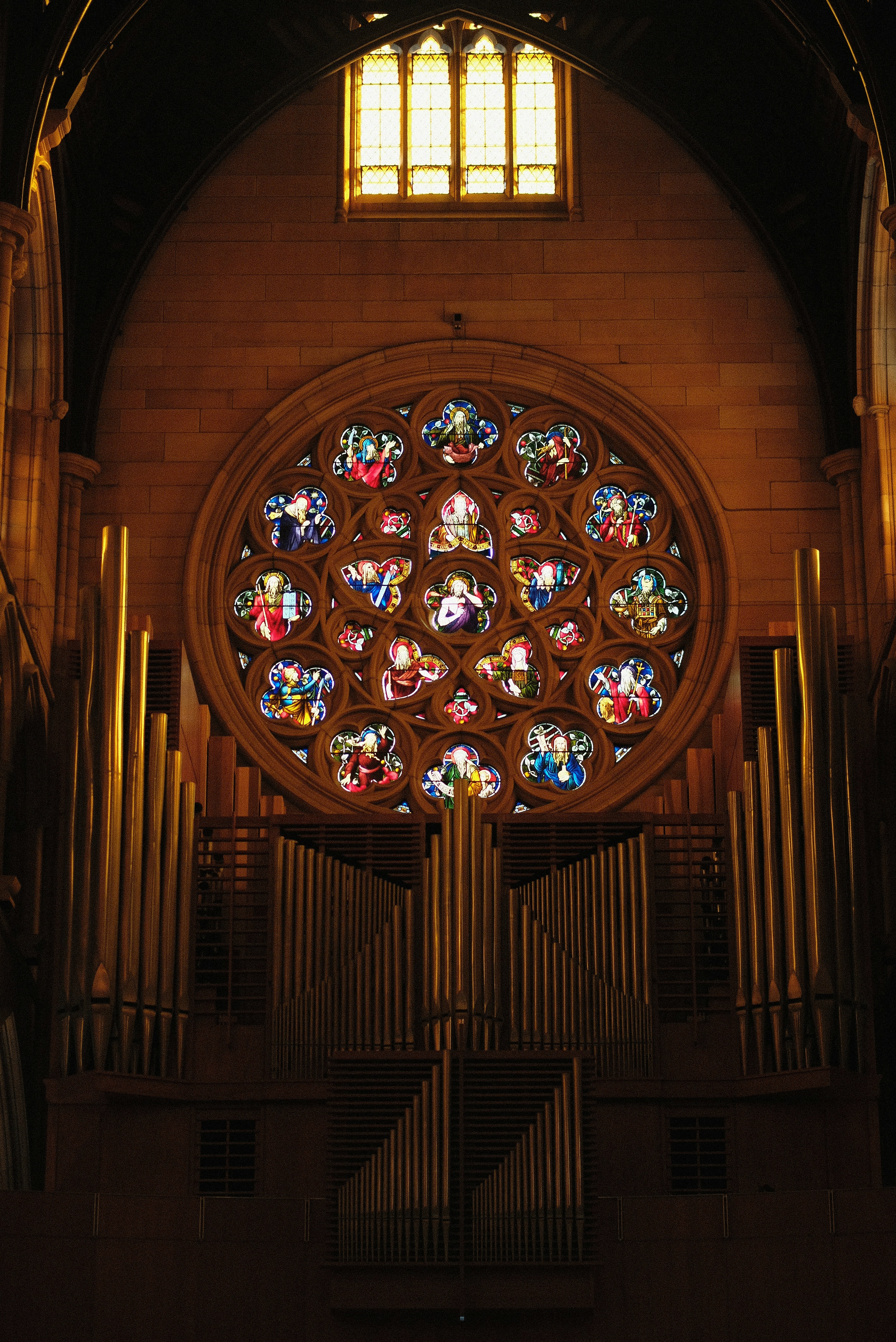 A large stained glass window inside of a church