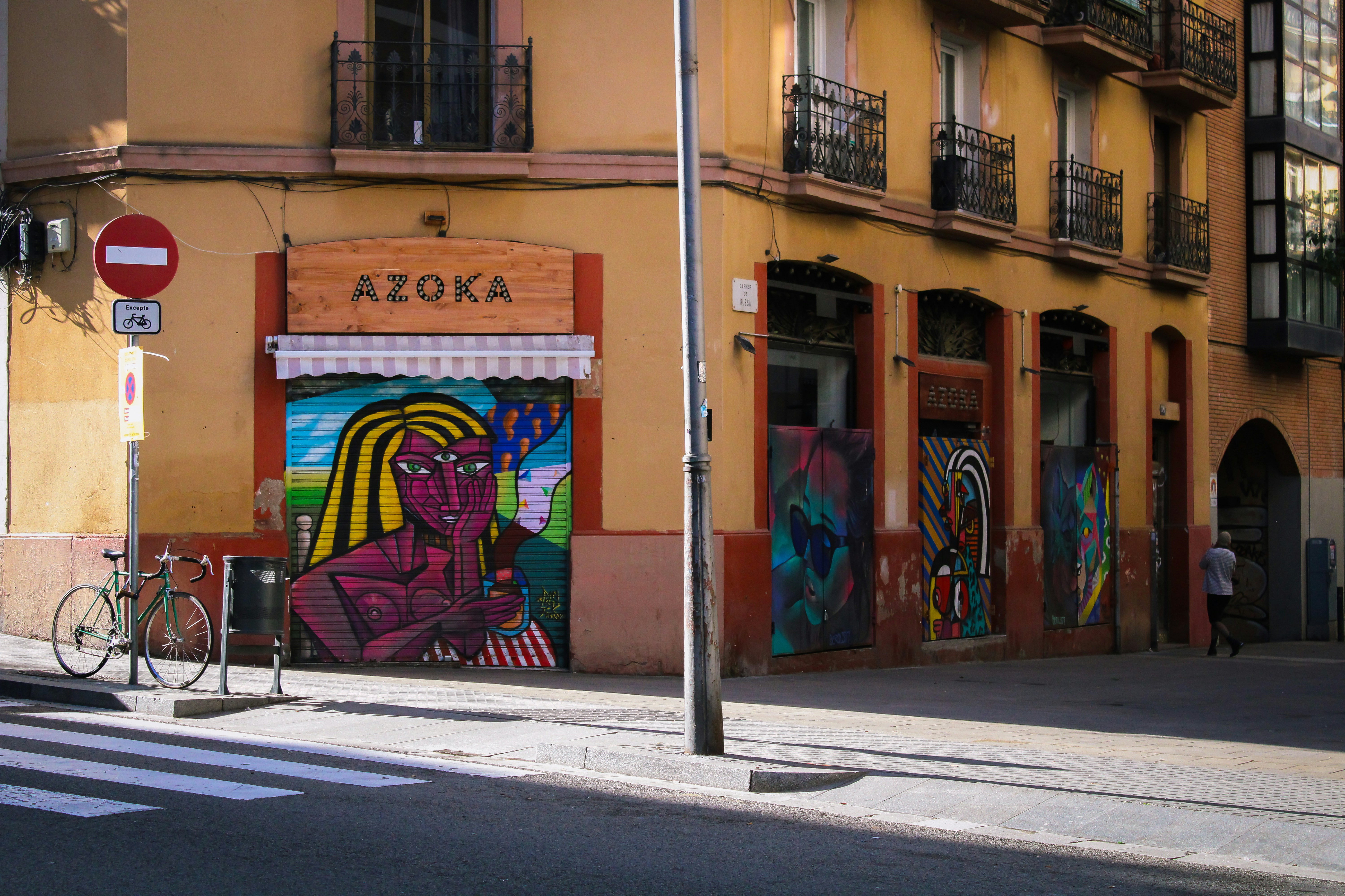 A street corner with a building with a mural on it
