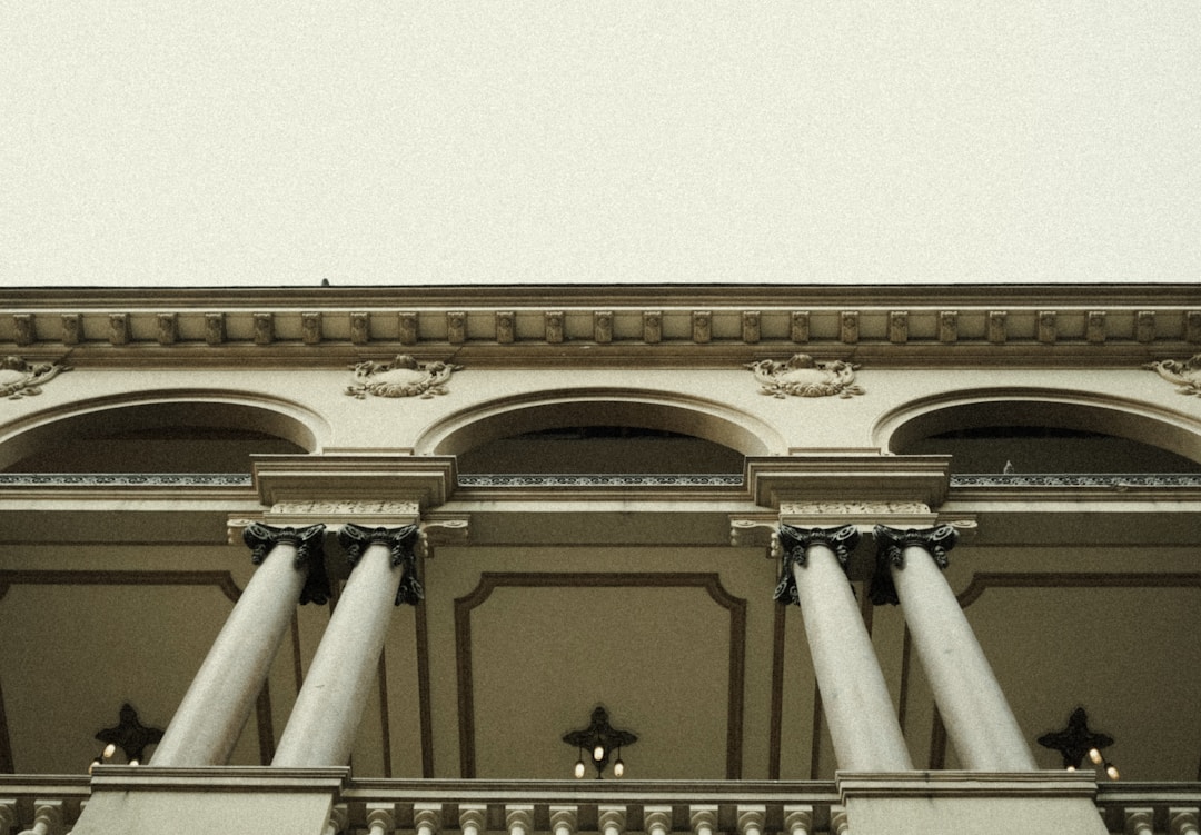 A bank building with columns and a clock on top