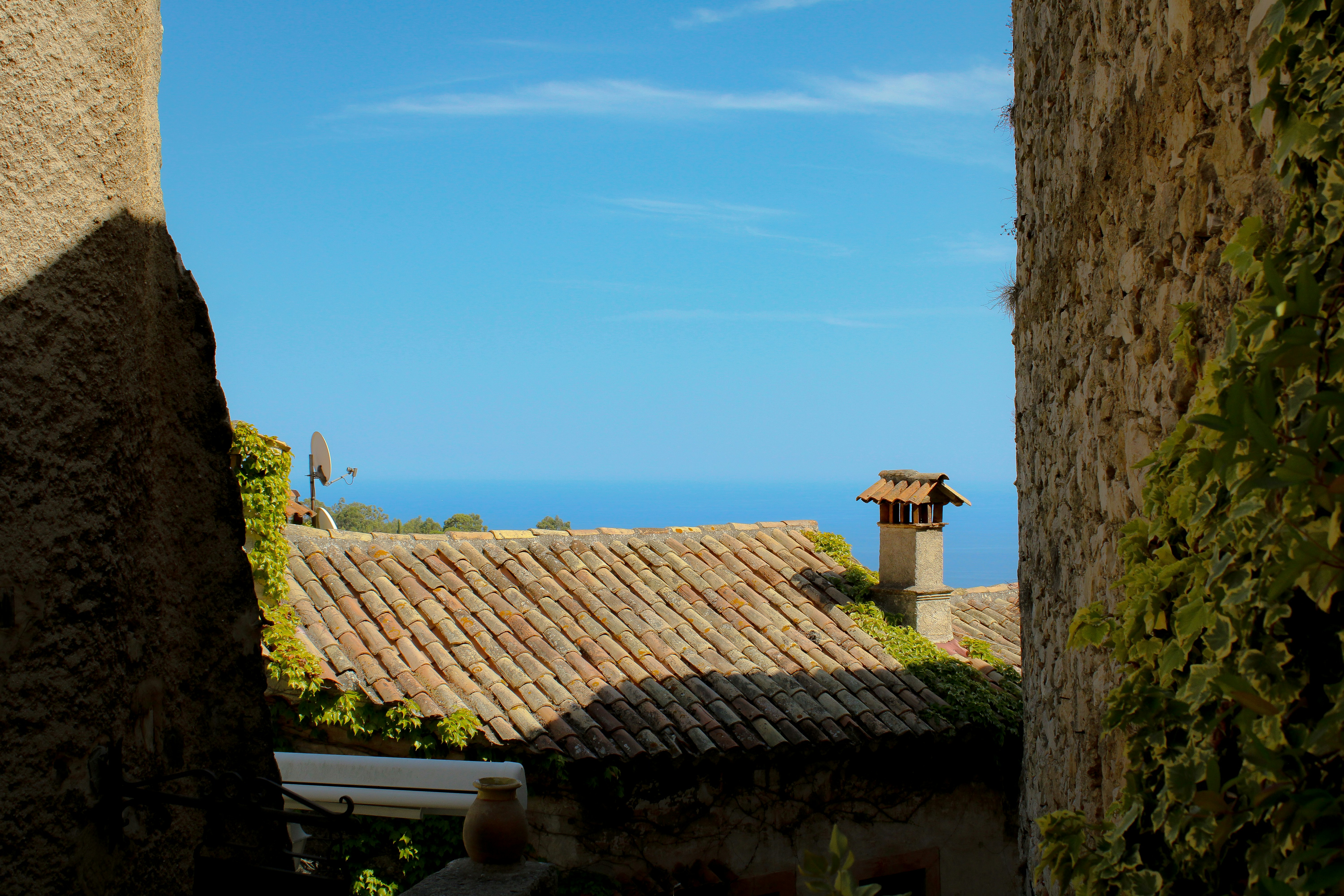 A view of the ocean from an alley way, 