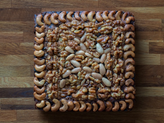 A square piece of food on a wooden surface