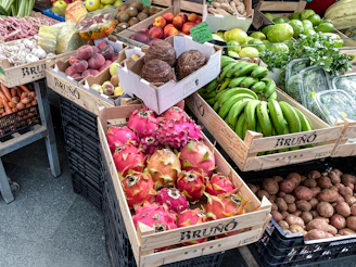 A bunch of boxes filled with lots of fruits and vegetables