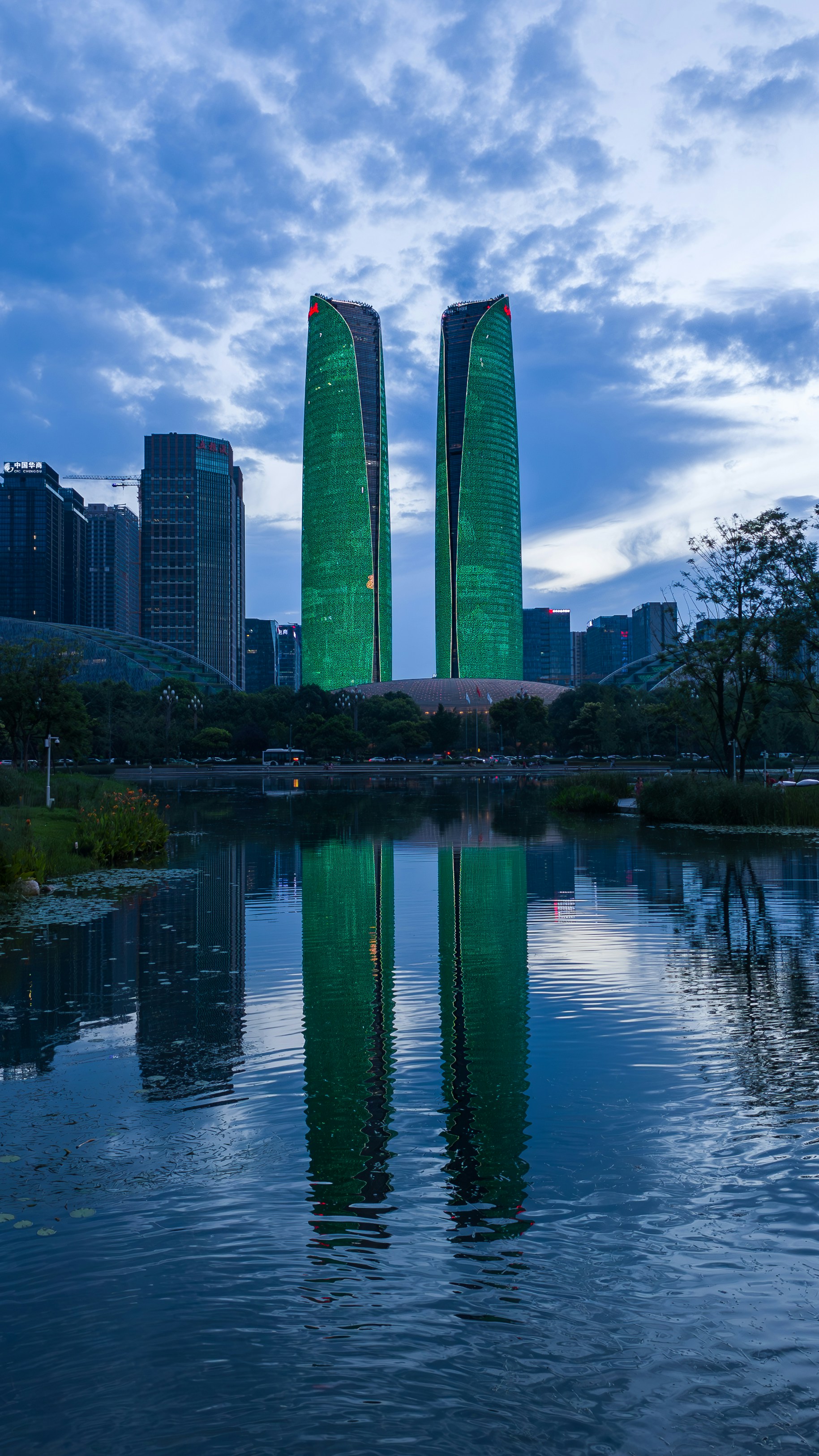 A body of water with two tall buildings in the background