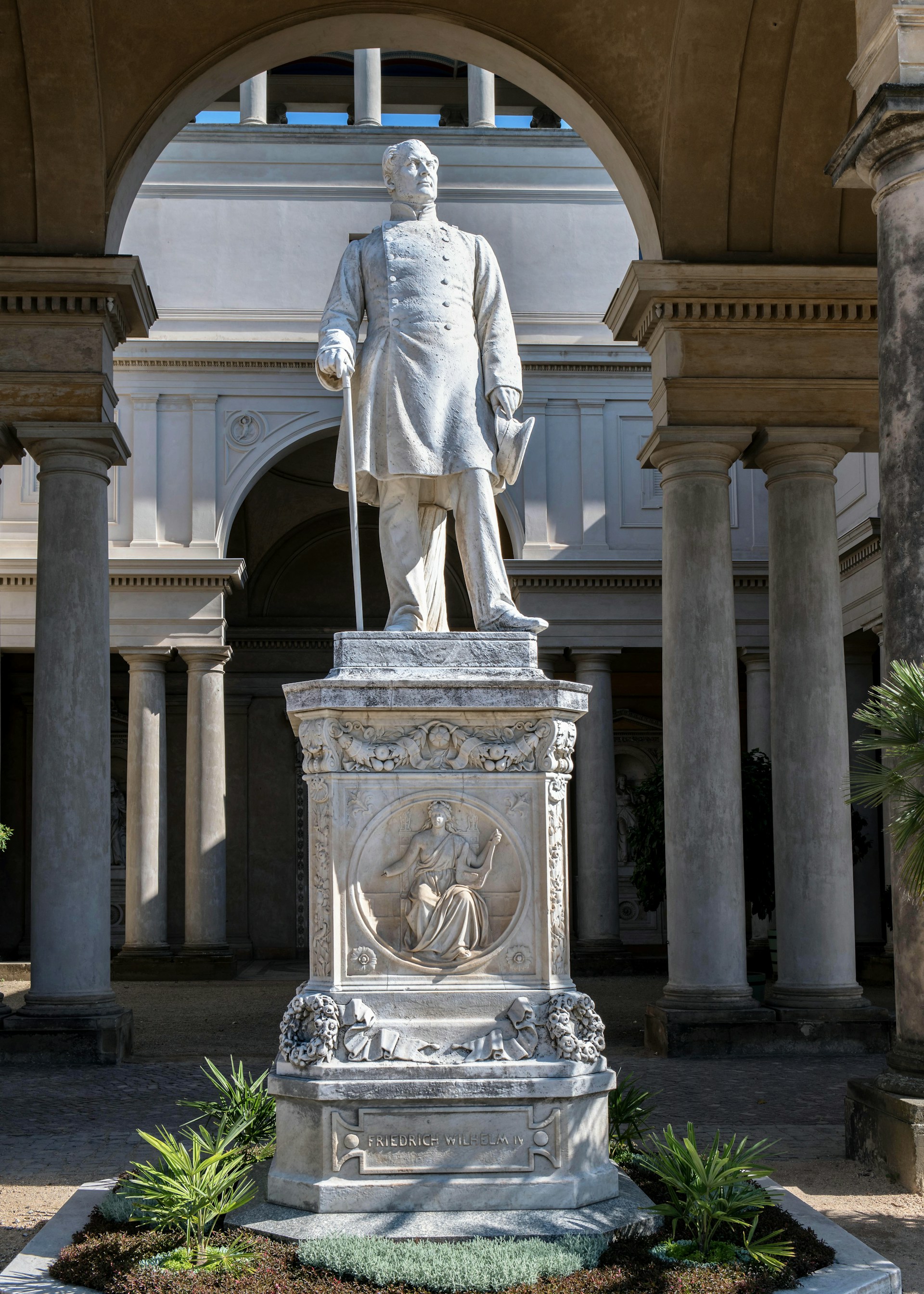 A statue of a man standing in front of a building