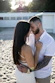 A man and woman standing on top of a sandy beach