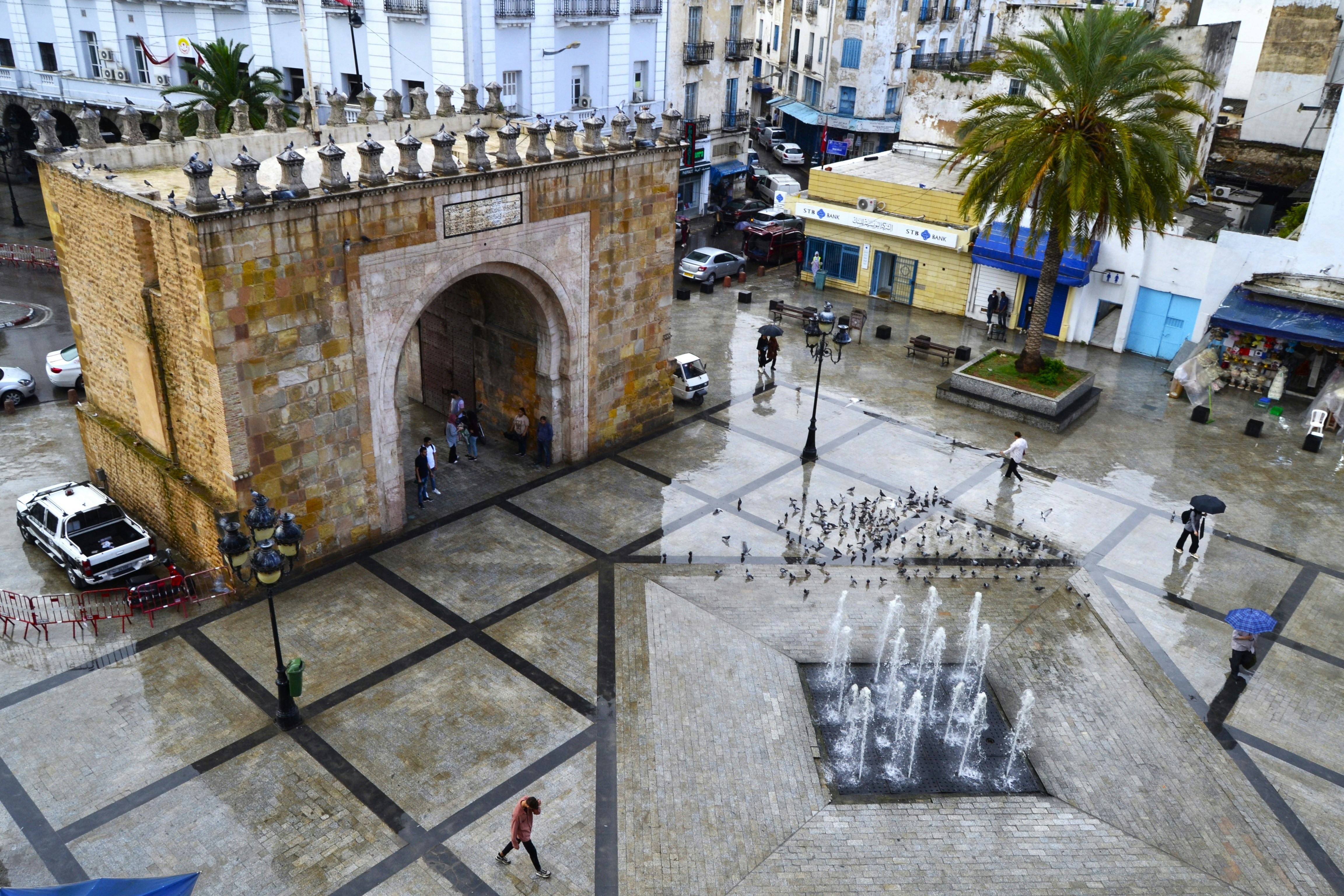 Bab al-Bhar gate and the fountain plaza approaching the entrance to the Medina of Tunis, the capital city of Tunisia. Views from the balcony of the Royal Victoria Hotel.