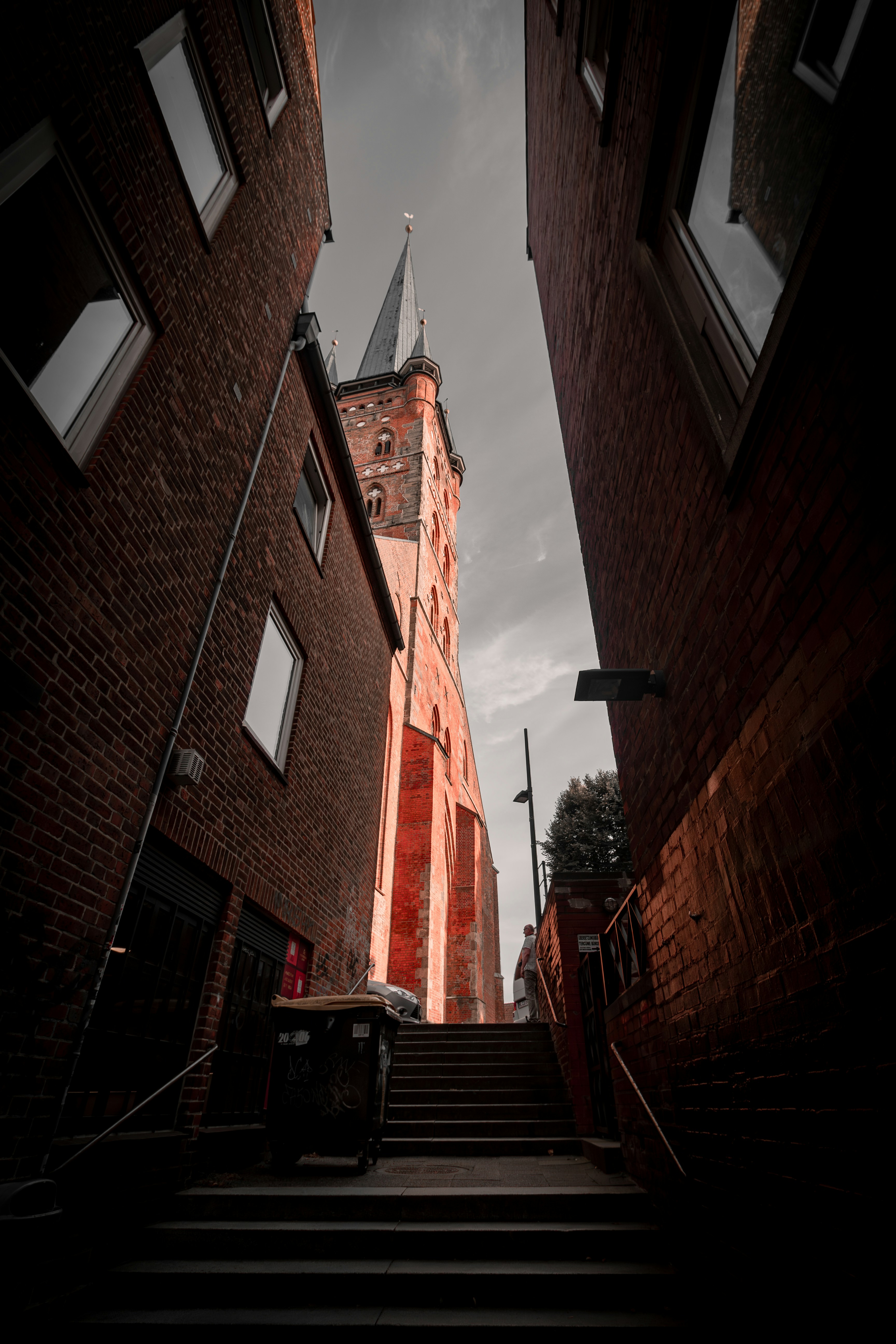 A very tall building with a steeple next to it