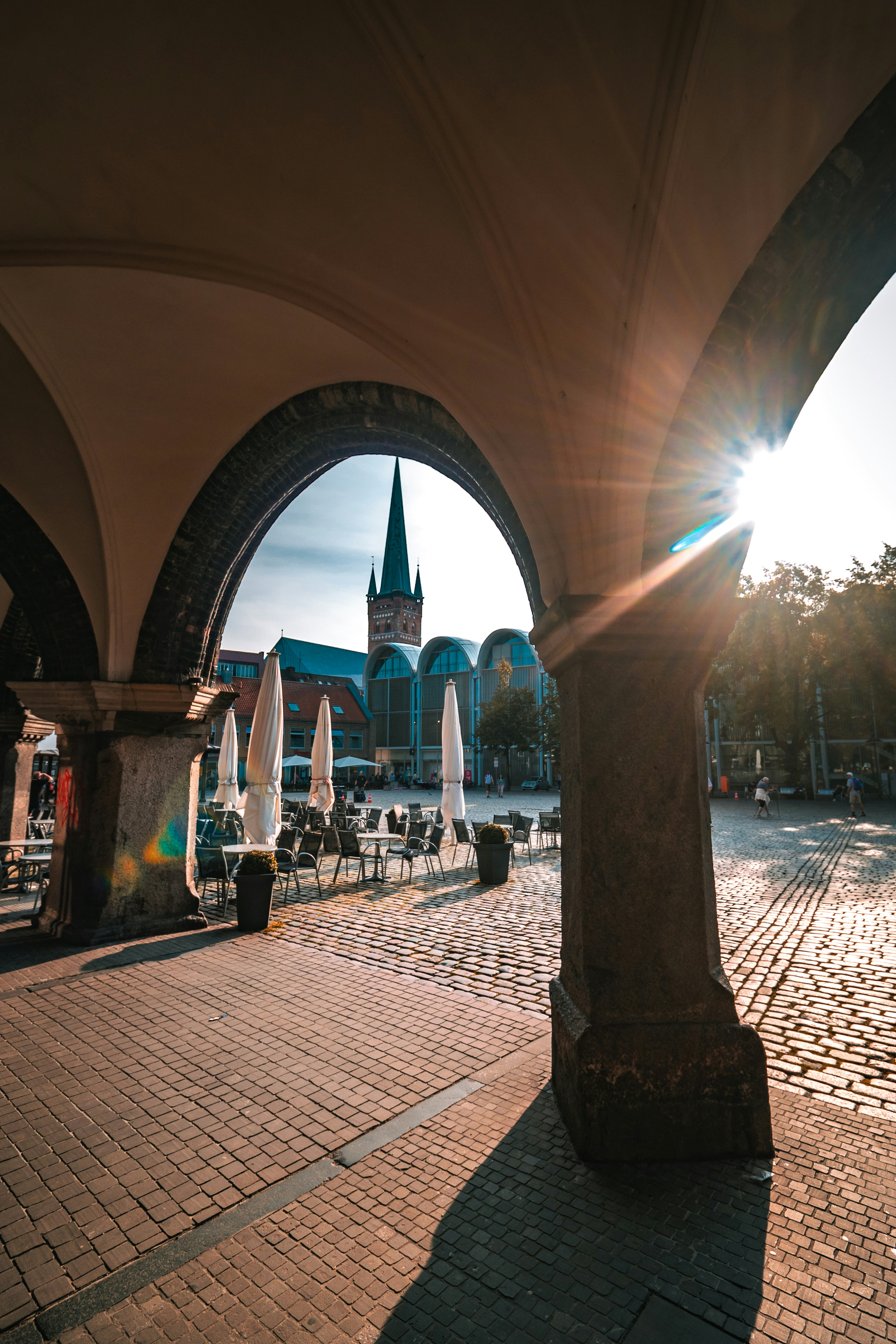 The sun is shining through the arches of a building