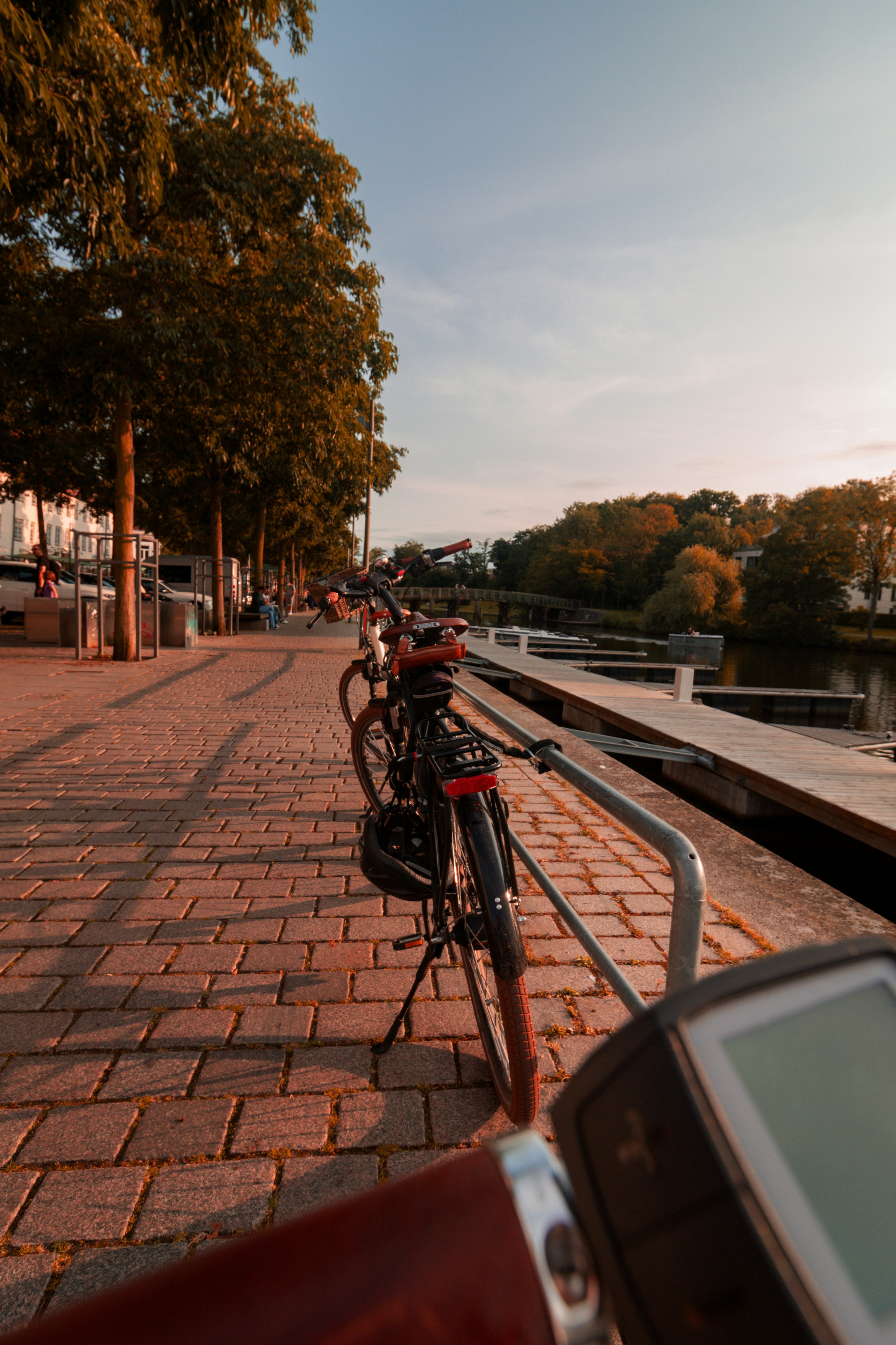 a row of bikes parked on a sidewalk