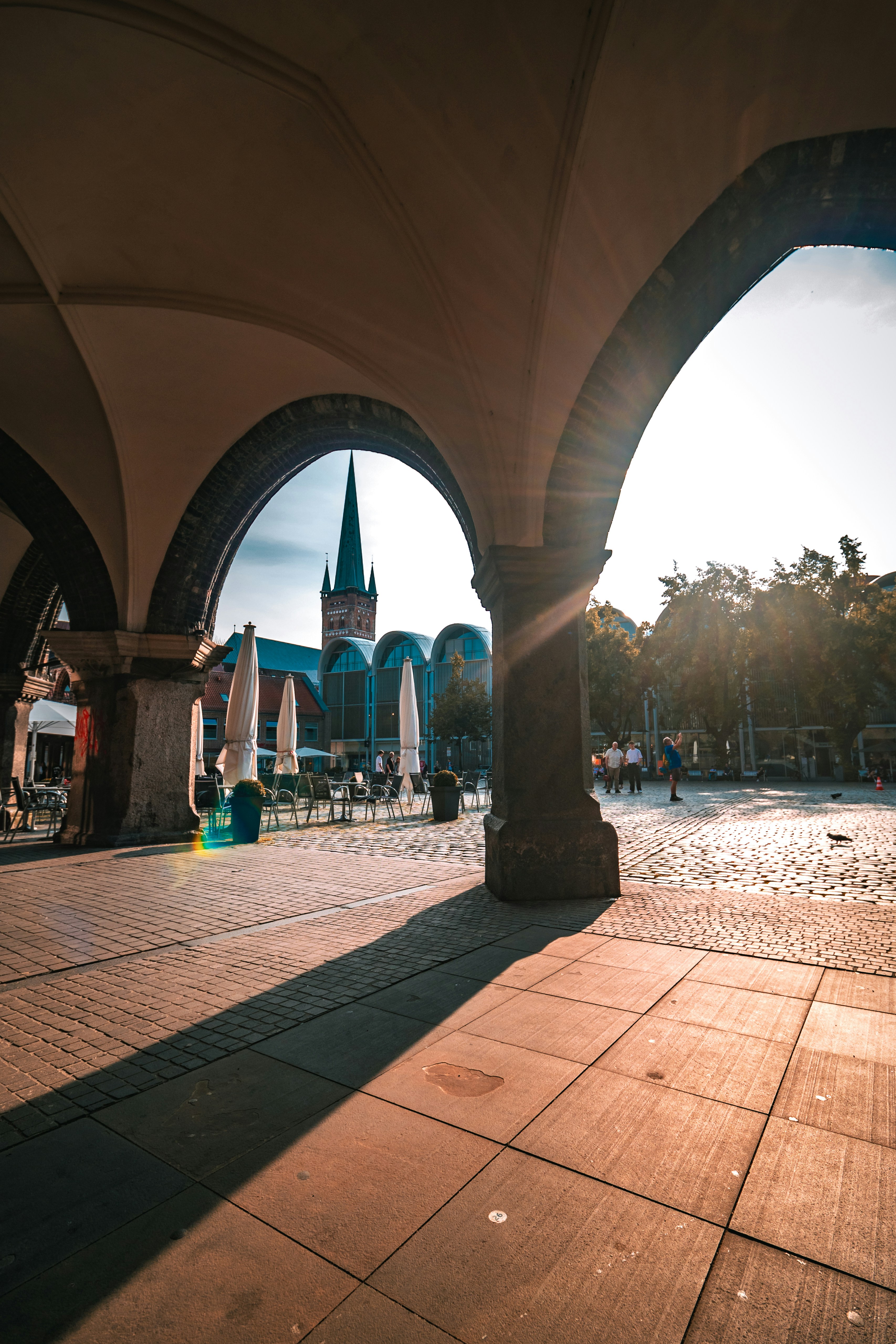 The sun is shining through the arches of a building