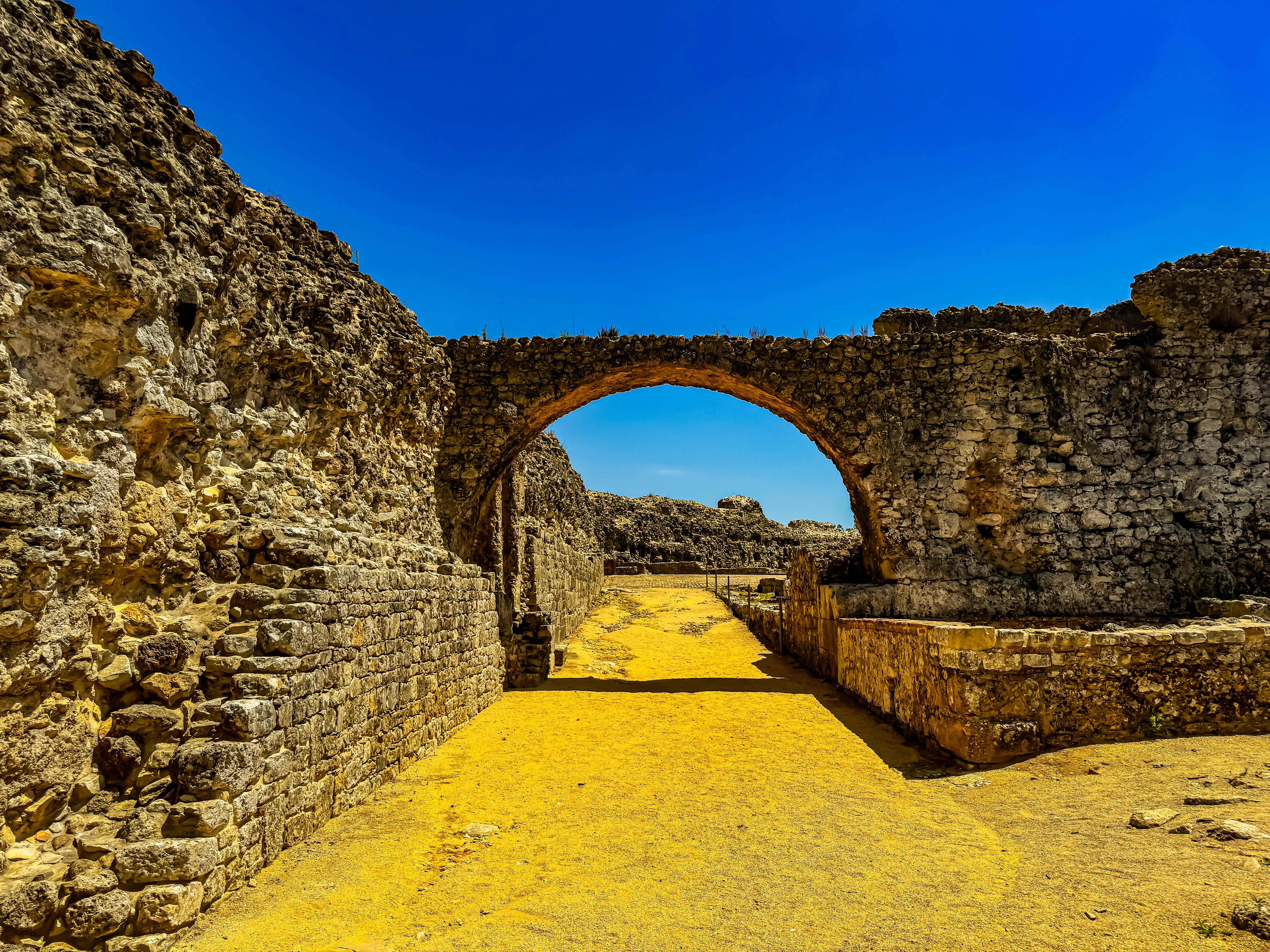 A tunnel in the middle of a stone wall