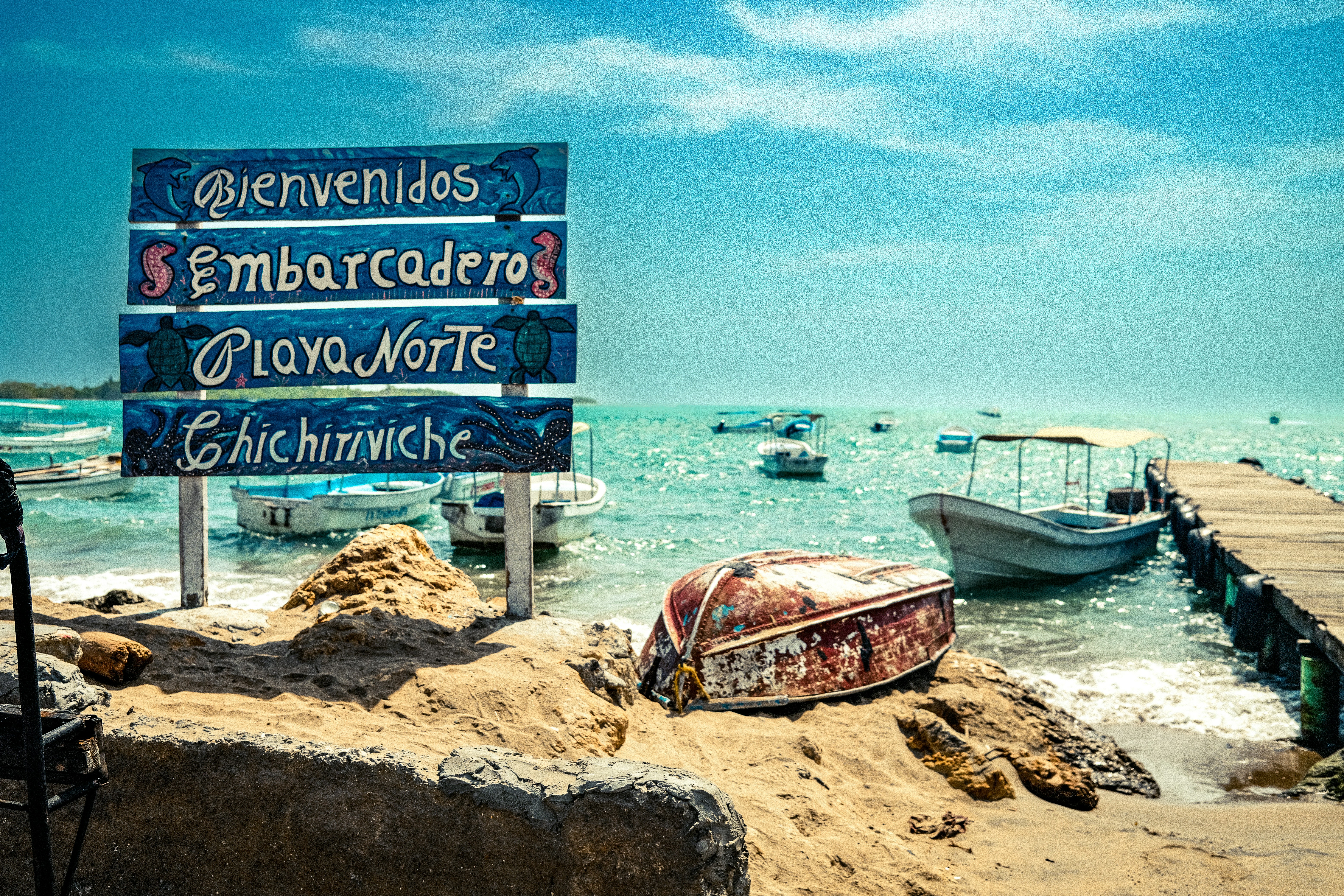 A sign that is on the side of a beach