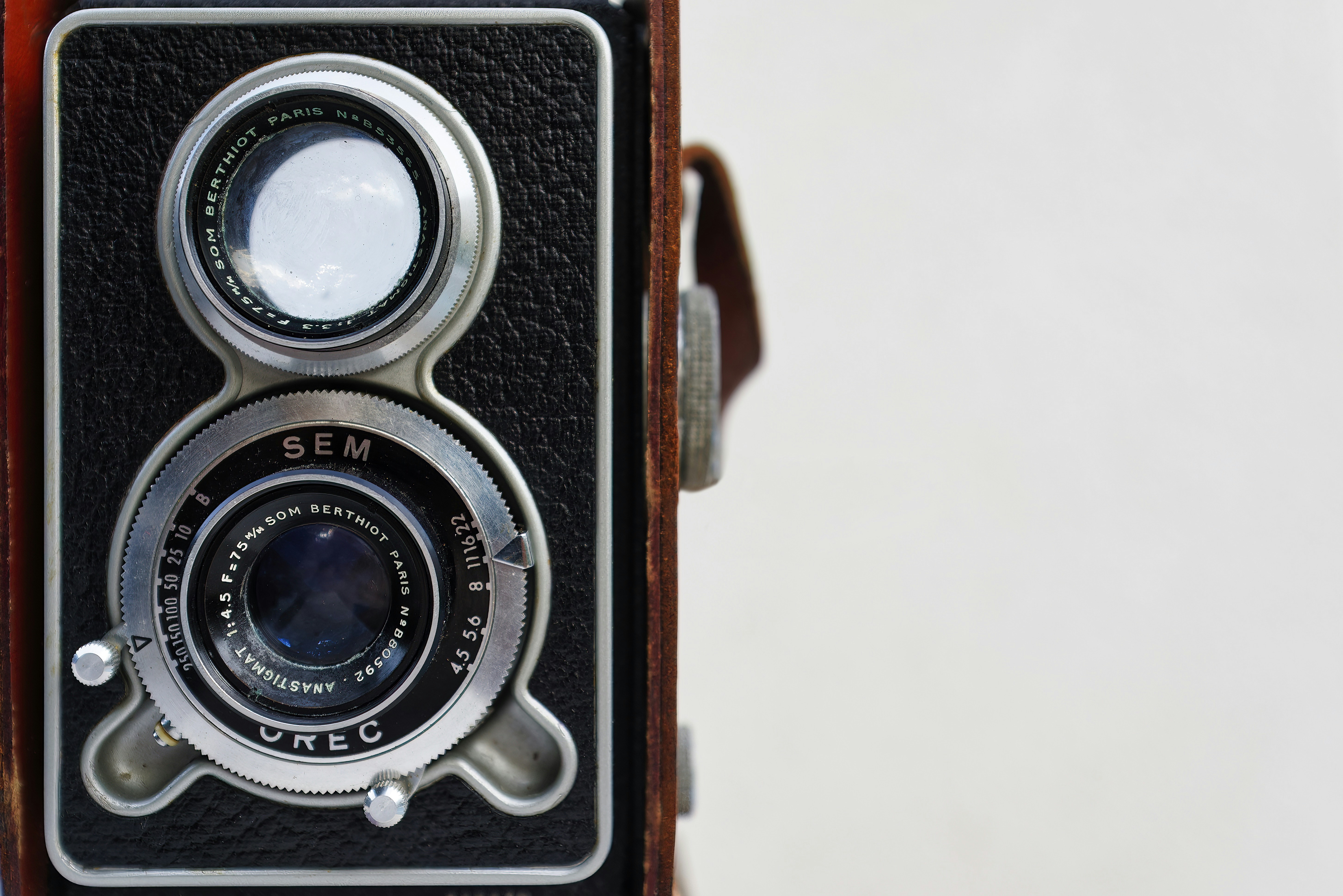 An old fashioned camera with a leather case
